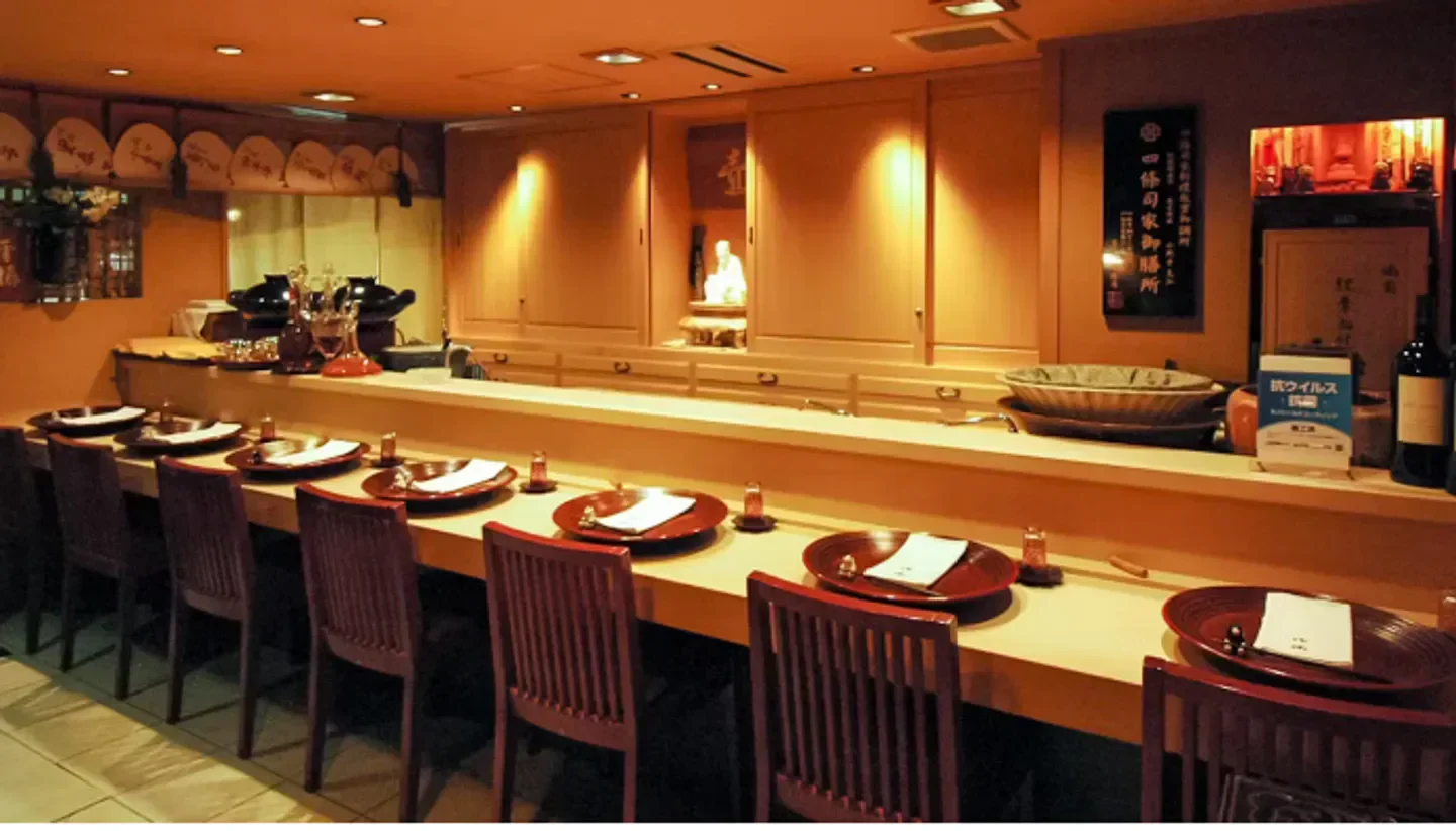 Cozy interior of Ginza Fukuju restaurant in Tokyo, with elegant sushi counter and seating.