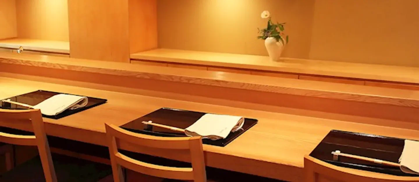 Cozy dining area at Ginza Toyoda restaurant in Tokyo, showcasing elegant wood design.