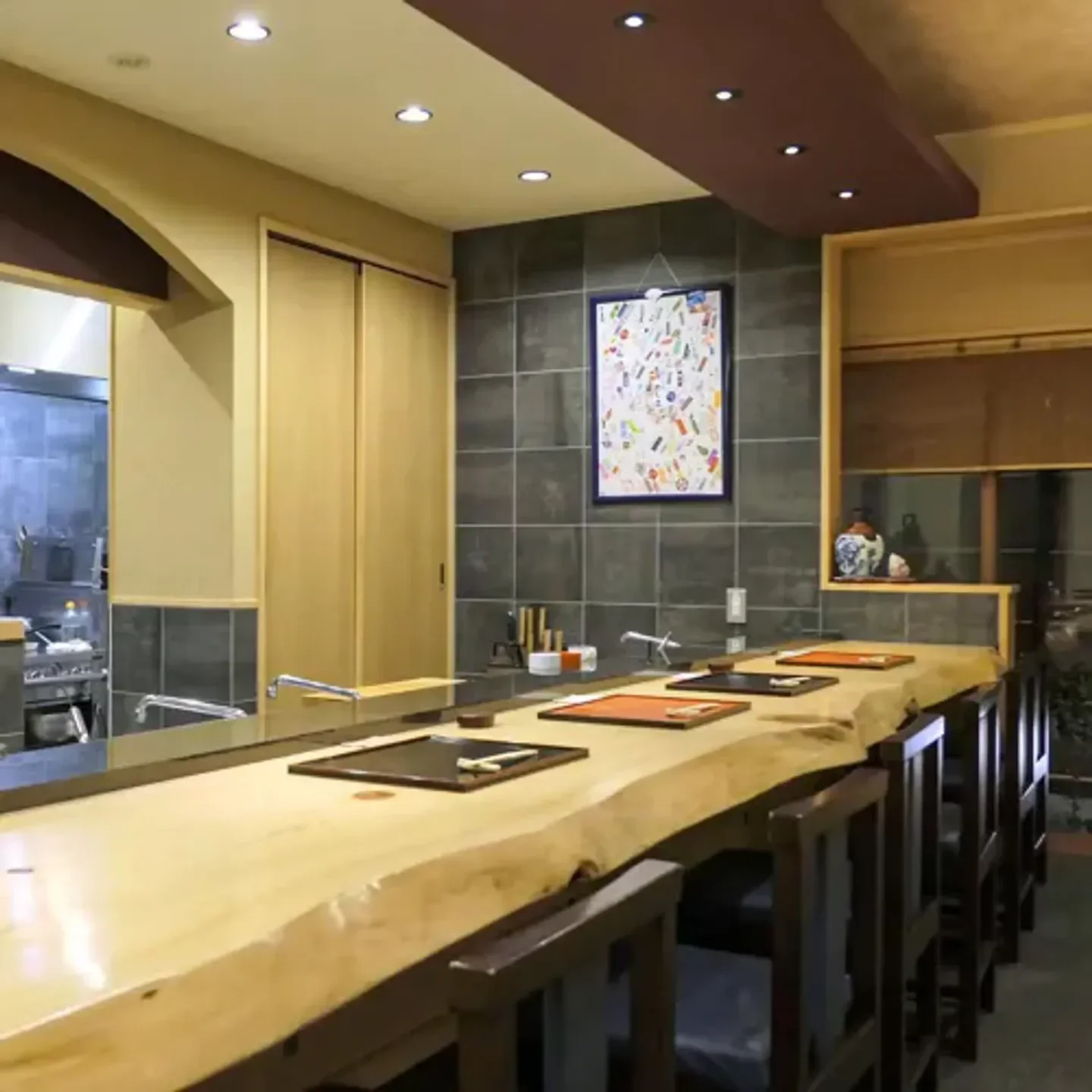 Interior of Gion Kajisho restaurant in Kyoto, with a natural wooden sushi counter