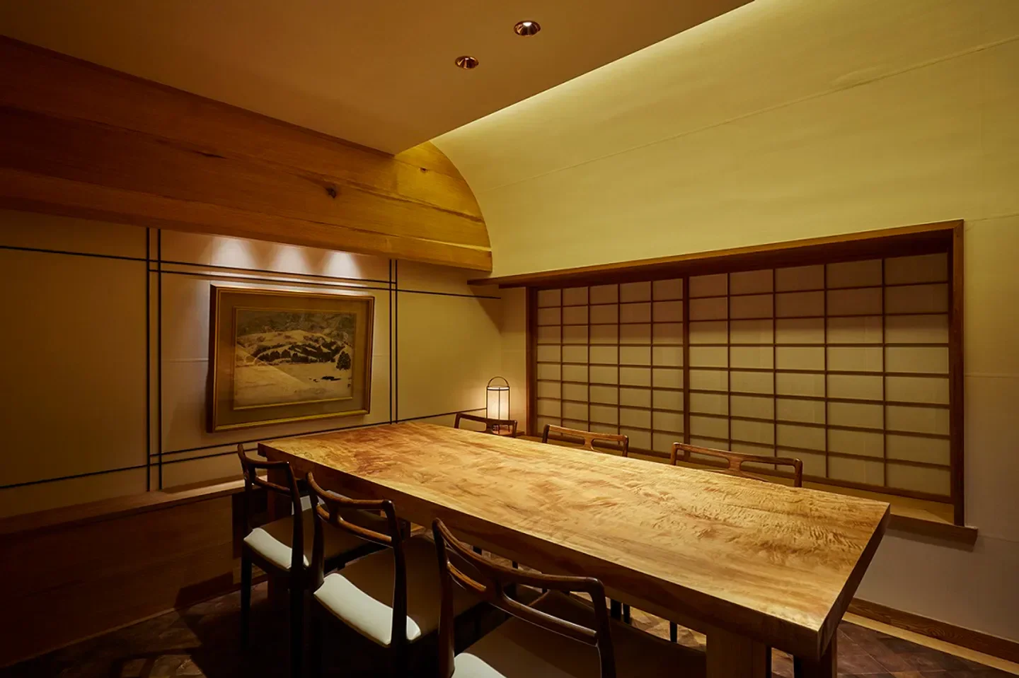 Interior dining space at Gion Mamma in Kyoto, featuring a large wooden table.