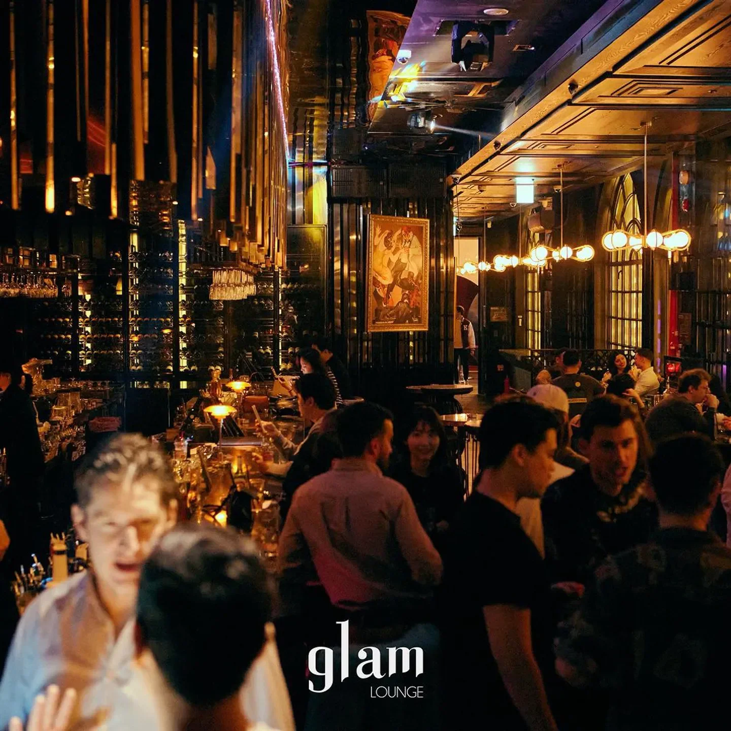 Glam Lounge in Seoul: Interior of a stylish nightclub with people and elegant lighting.