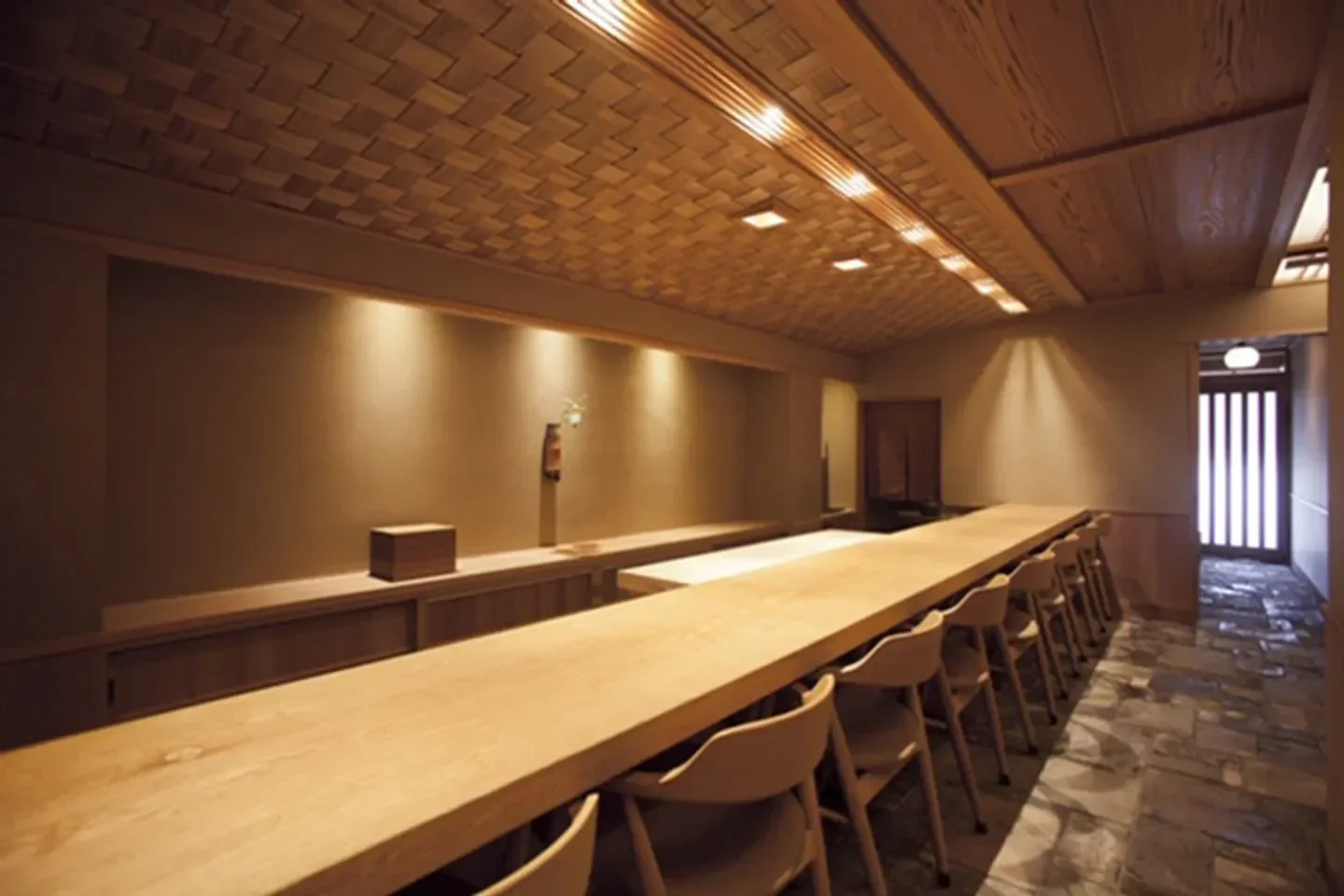 Interior of Godan Miyazawa restaurant in Kyoto, featuring wooden tables and elegant decor