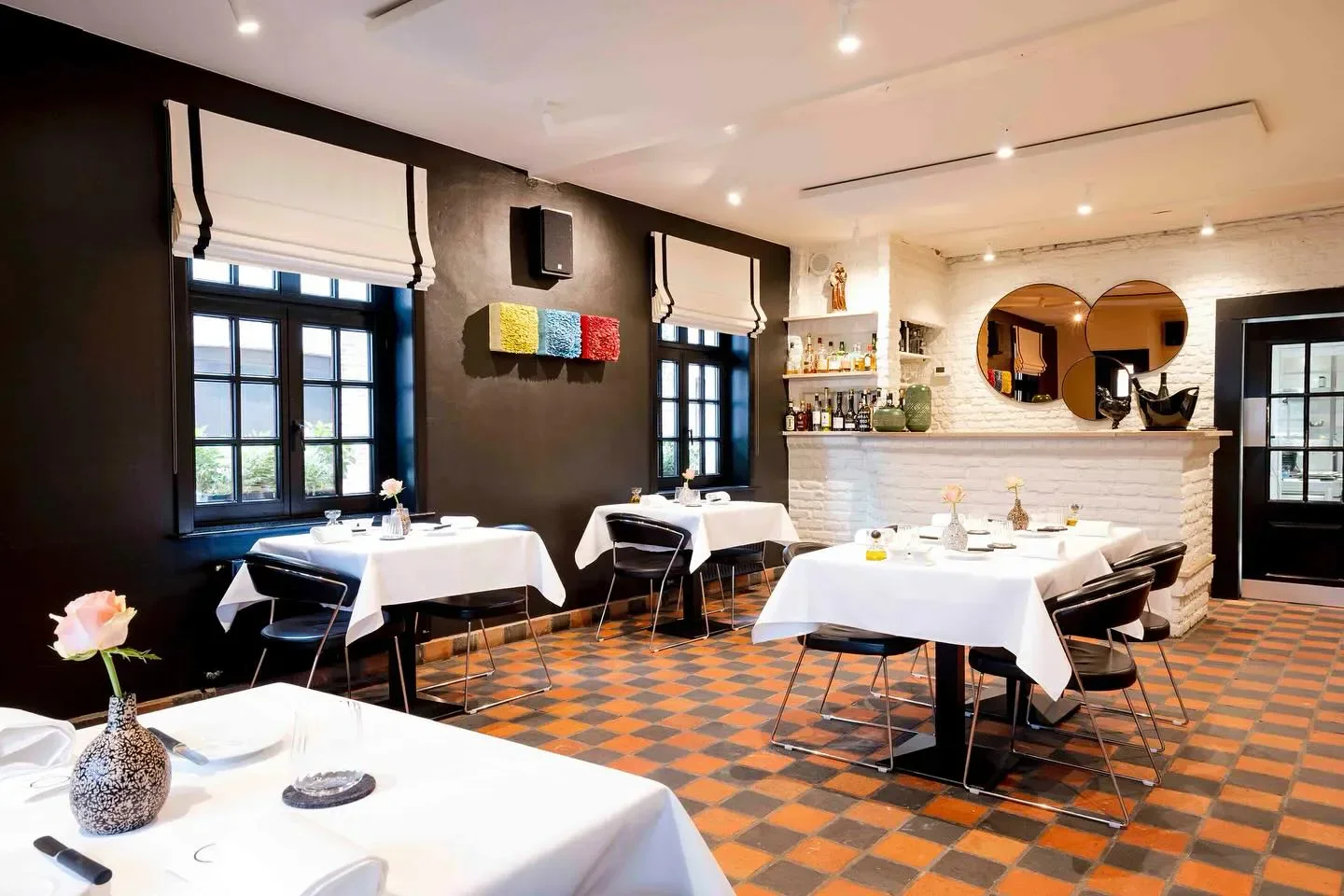 Interior dining at Goffin restaurant in Bruges with stylish tables and decor.