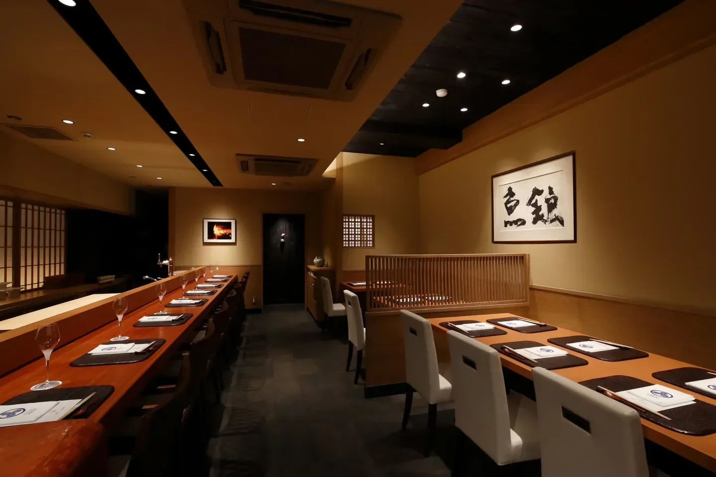 Interior of GOKAN UOGIN restaurant in Nara, featuring wooden tables and elegant design.