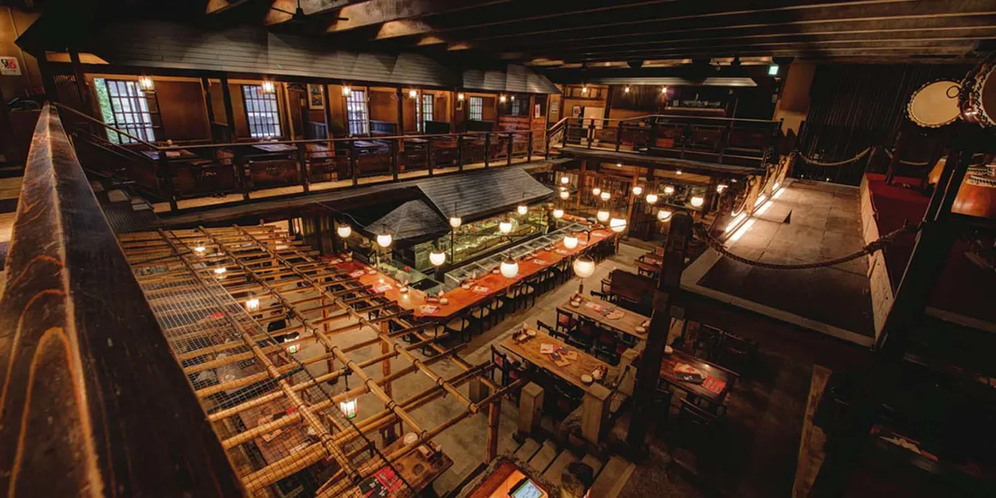 Interior view of Gonpachi Nishi-Azabu, a stylish restaurant in Tokyo, with multiple levels and dining areas.