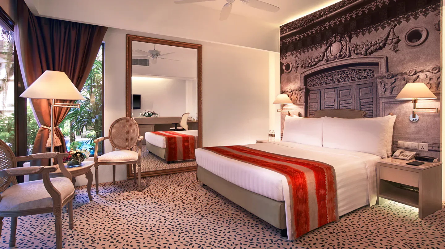 Cozy bedroom at Goodwood Park Hotel, Singapore, with elegant decor and inviting ambiance.