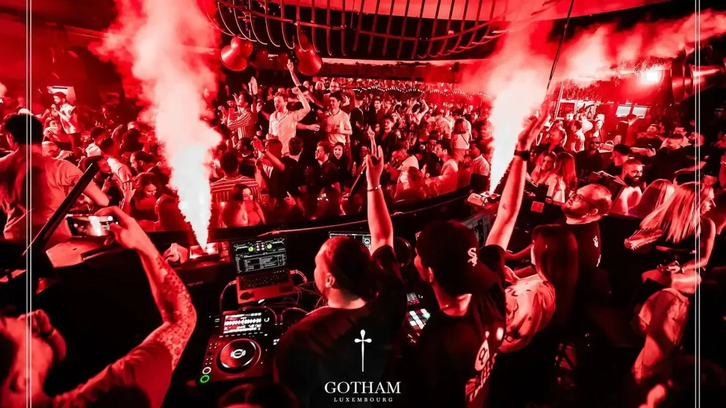 Energetic nightclub scene at Gotham in Luxembourg, with a DJ and a packed dance floor.