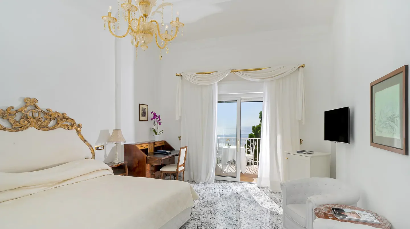 Elegant bedroom with sea view at the Grand Hotel Quisisana in Capri, Italy.