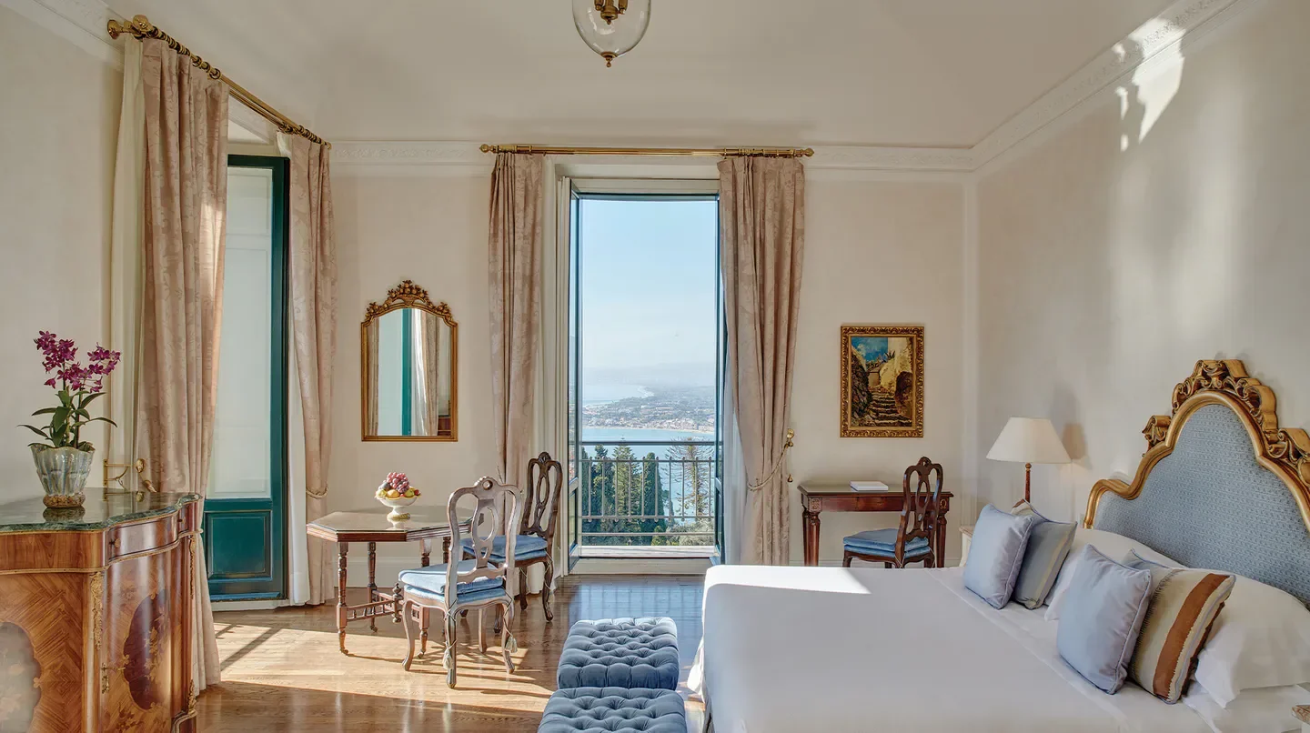 Elegant bedroom with balcony view at the Grand Hotel Timeo, in Taormina, Sicily.
