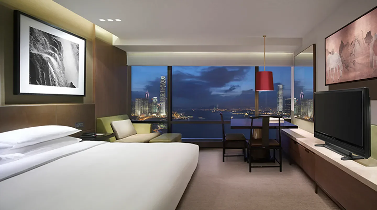 Grand Hyatt Hong Kong hotel room with stunning Hong Kong city skyline views at dusk.