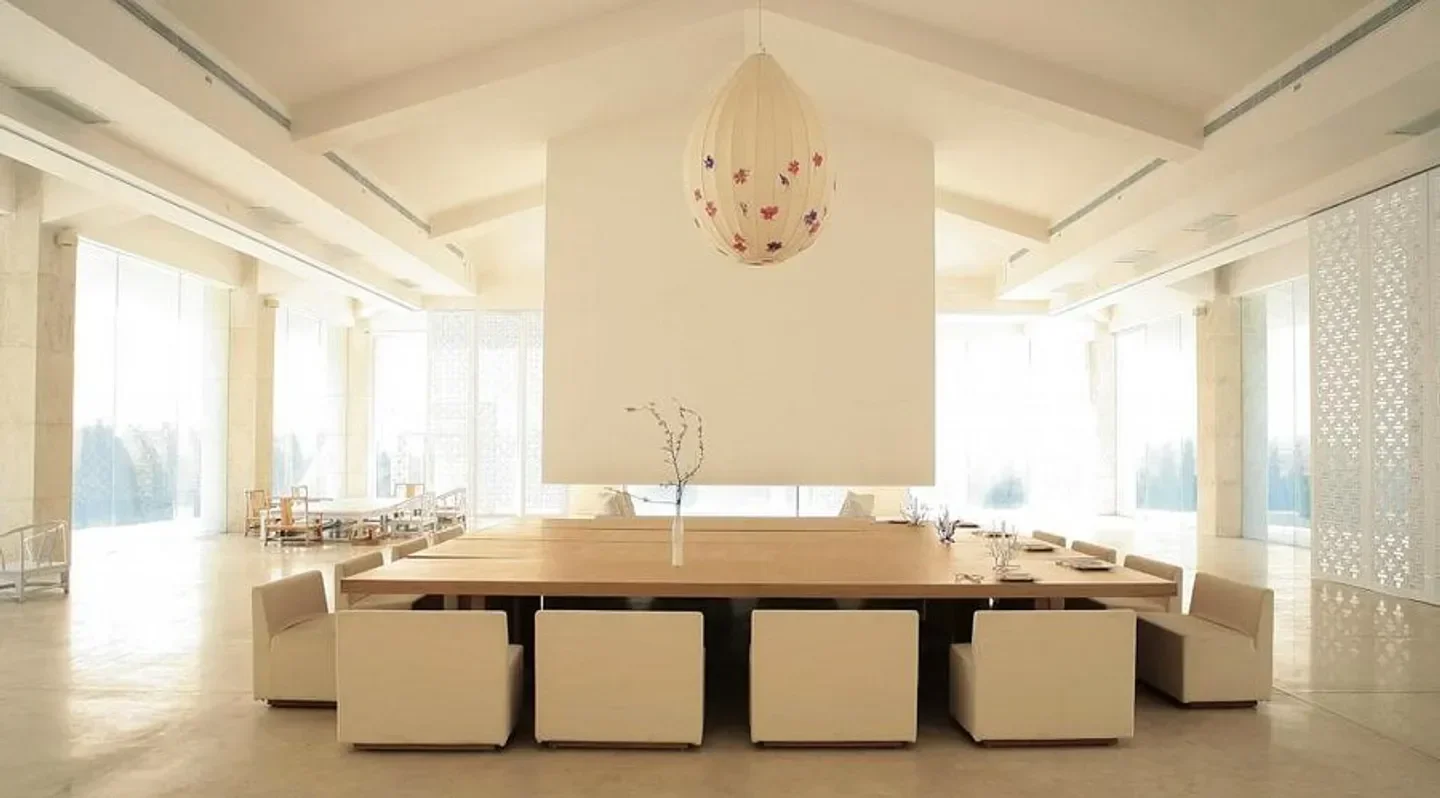 Elegant dining room interior at Green T House restaurant in Beijing, featuring a large table.