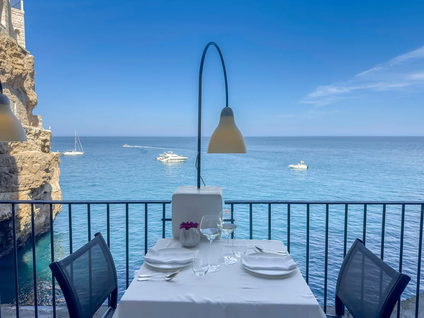 Table set for dining with a breathtaking sea view at Grotta Palazzese restaurant in Puglia