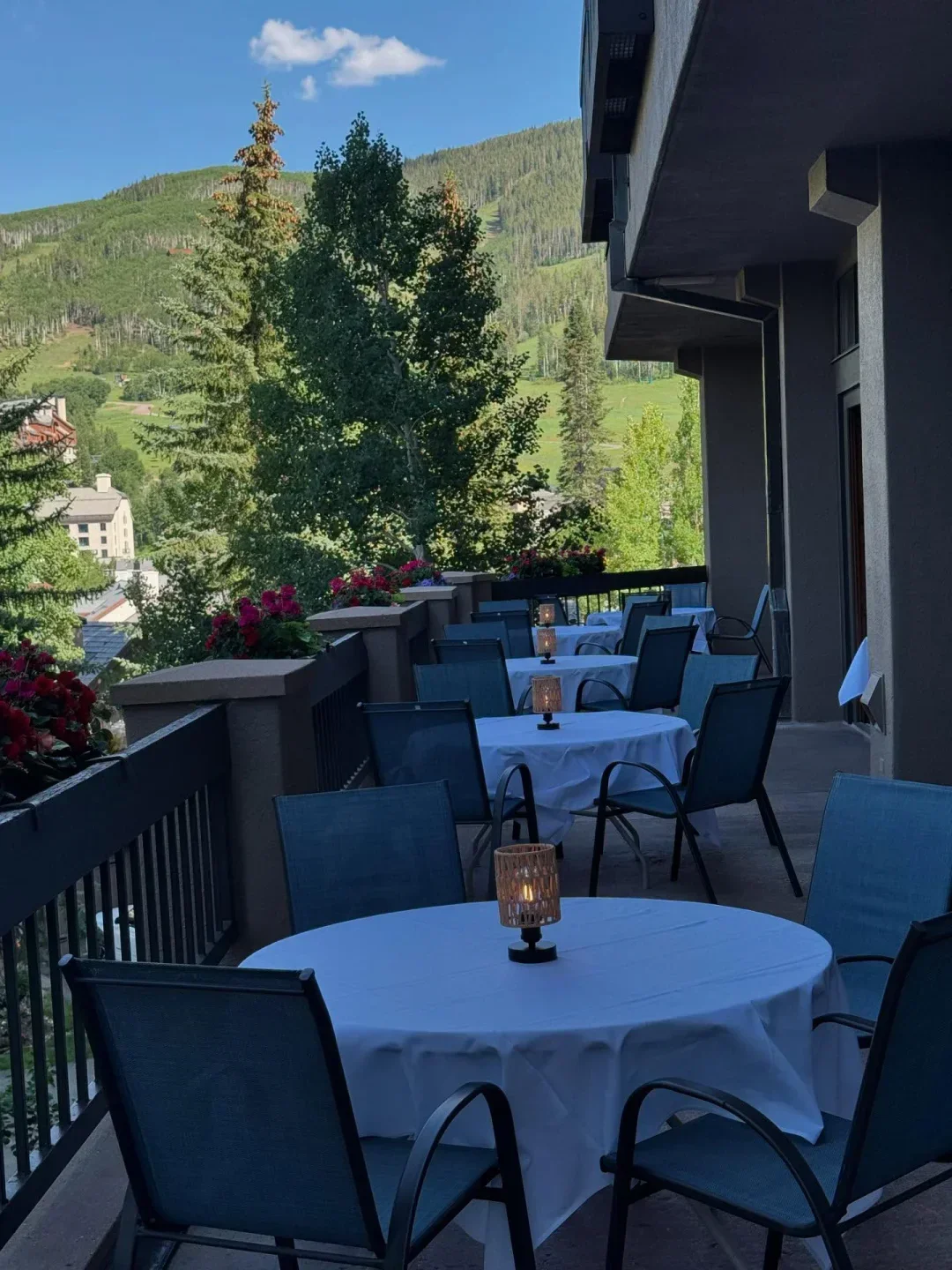 Outdoor seating at Grouse Mountain Grill in Vail with mountain views and candlelight