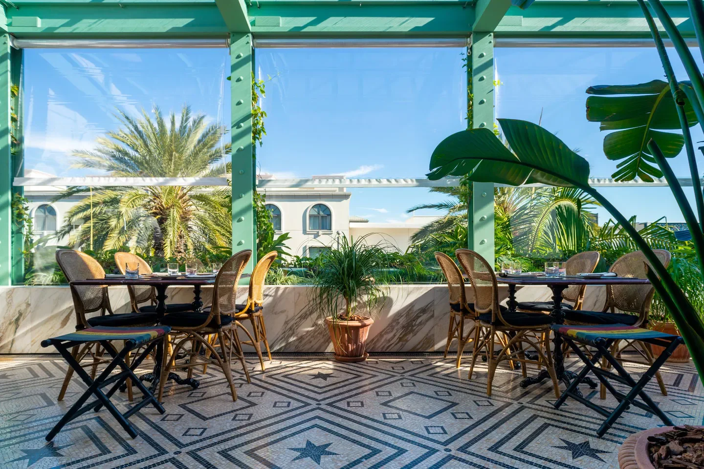 Outdoor dining at Gucci Osteria da Massimo Bottura - Florence with tiled floor and garden views