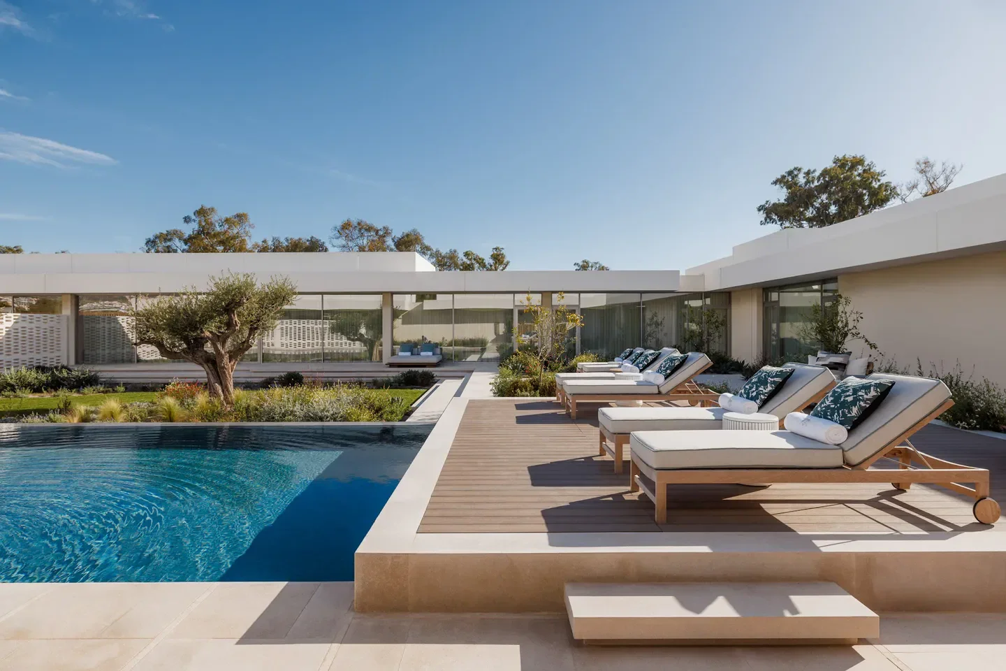 Guerlain Spa at One&Only Aesthesis in Athens: Luxurious poolside with sun loungers.