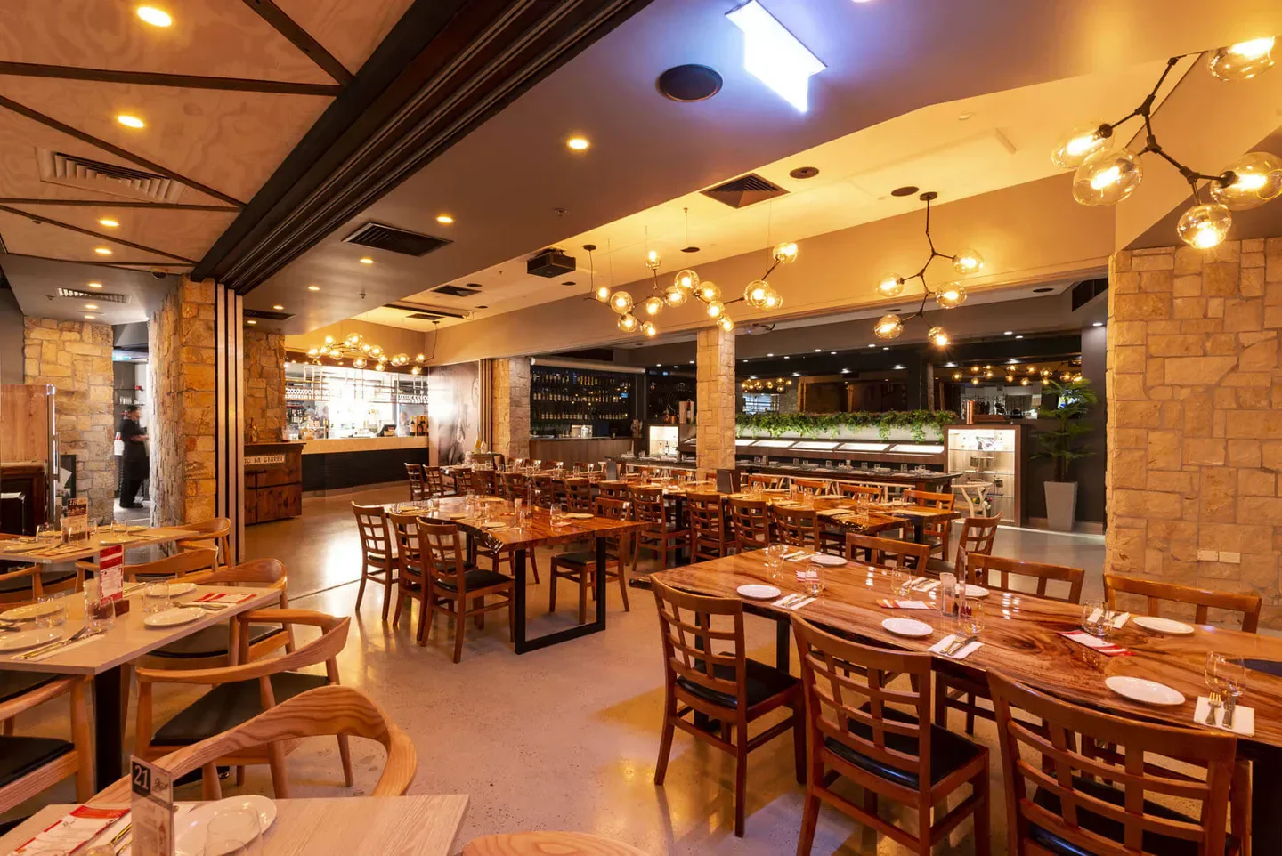 Interior of Gusto da Gianni restaurant in Brisbane, showing dining tables and warm lighting.