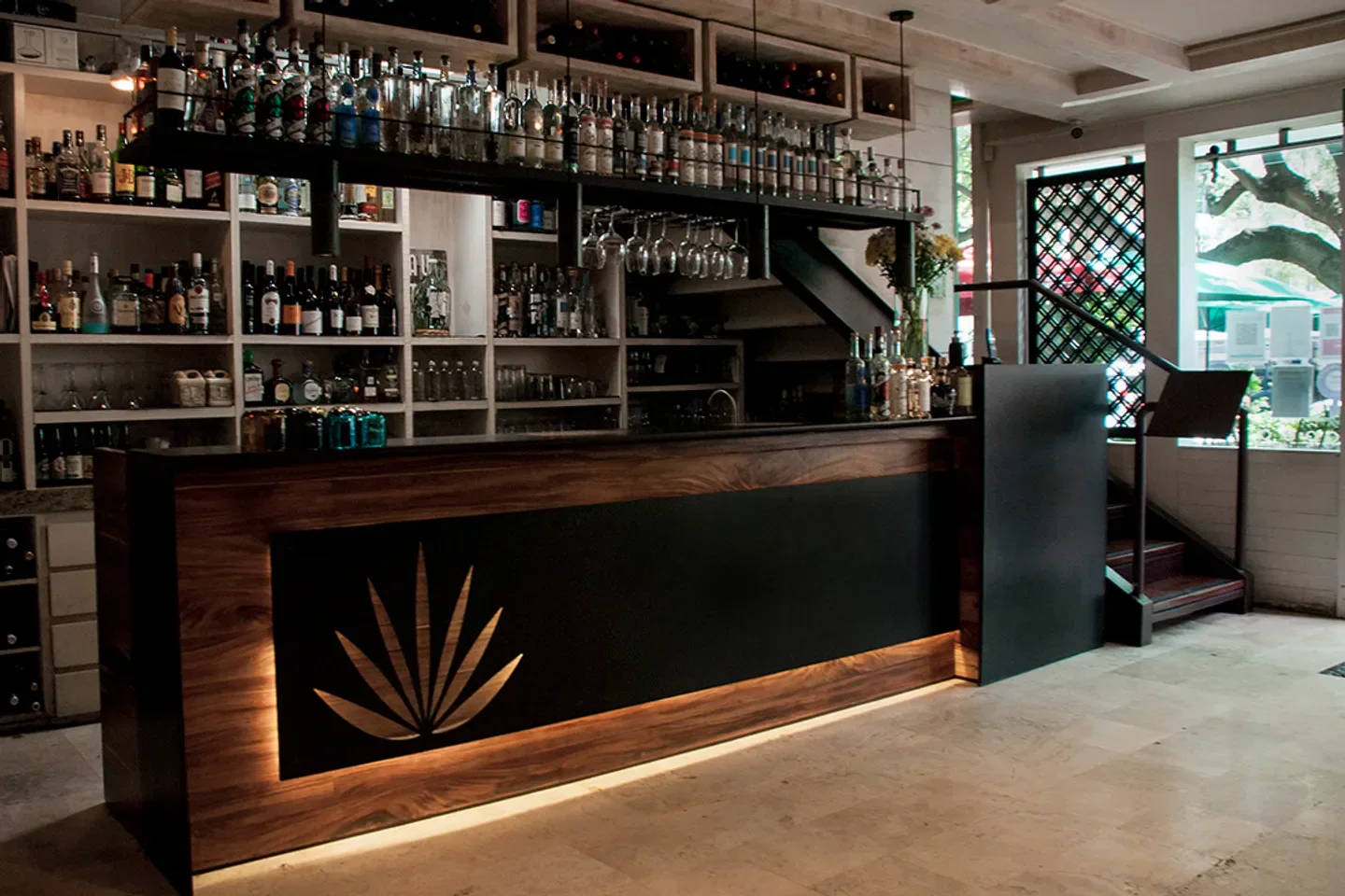 Interior of Guzina Oaxaca restaurant in Mexico City, showcasing the stylish bar area.