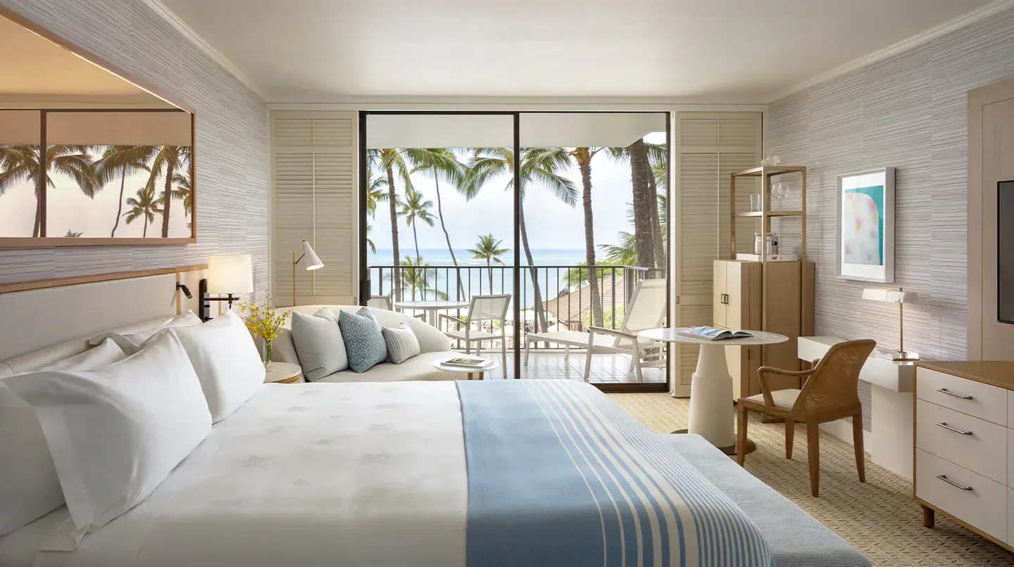 Halekulani hotel room in Oahu with a view of palm trees and the ocean
