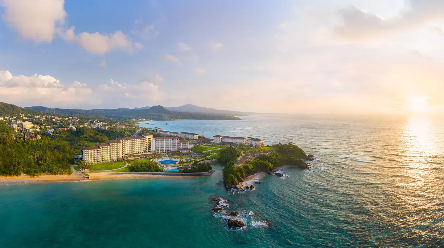 Aerial view of Halekulani Okinawa resort in Okinawa, Japan, with ocean and sunset