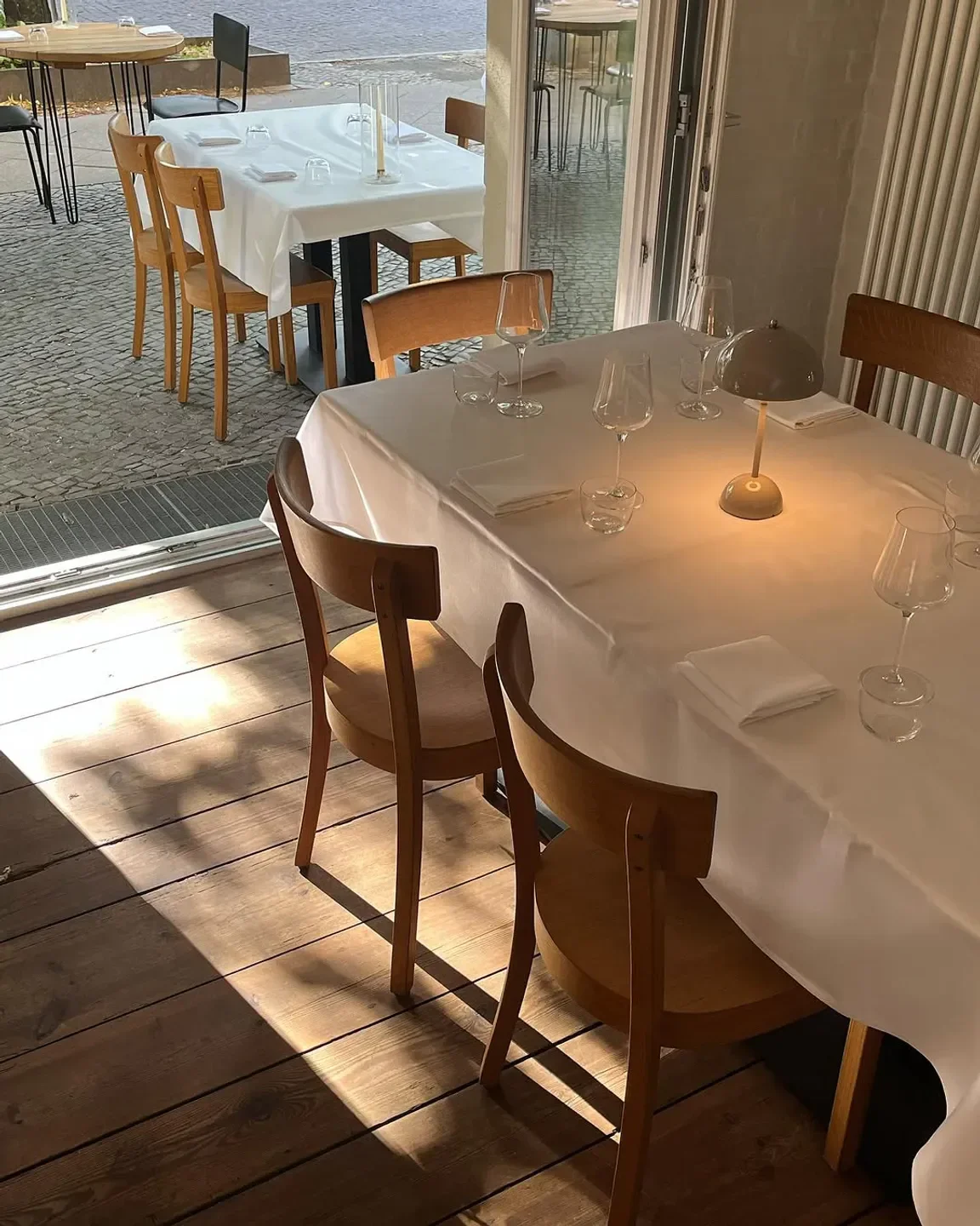 Cozy dining area at hallmann & klee restaurant in Berlin, with natural light and elegant setting.