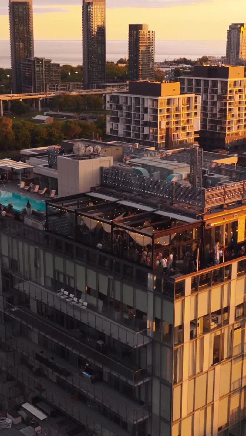 View of Harriet's Rooftop in Toronto with city skyline and waterfront during golden hour.