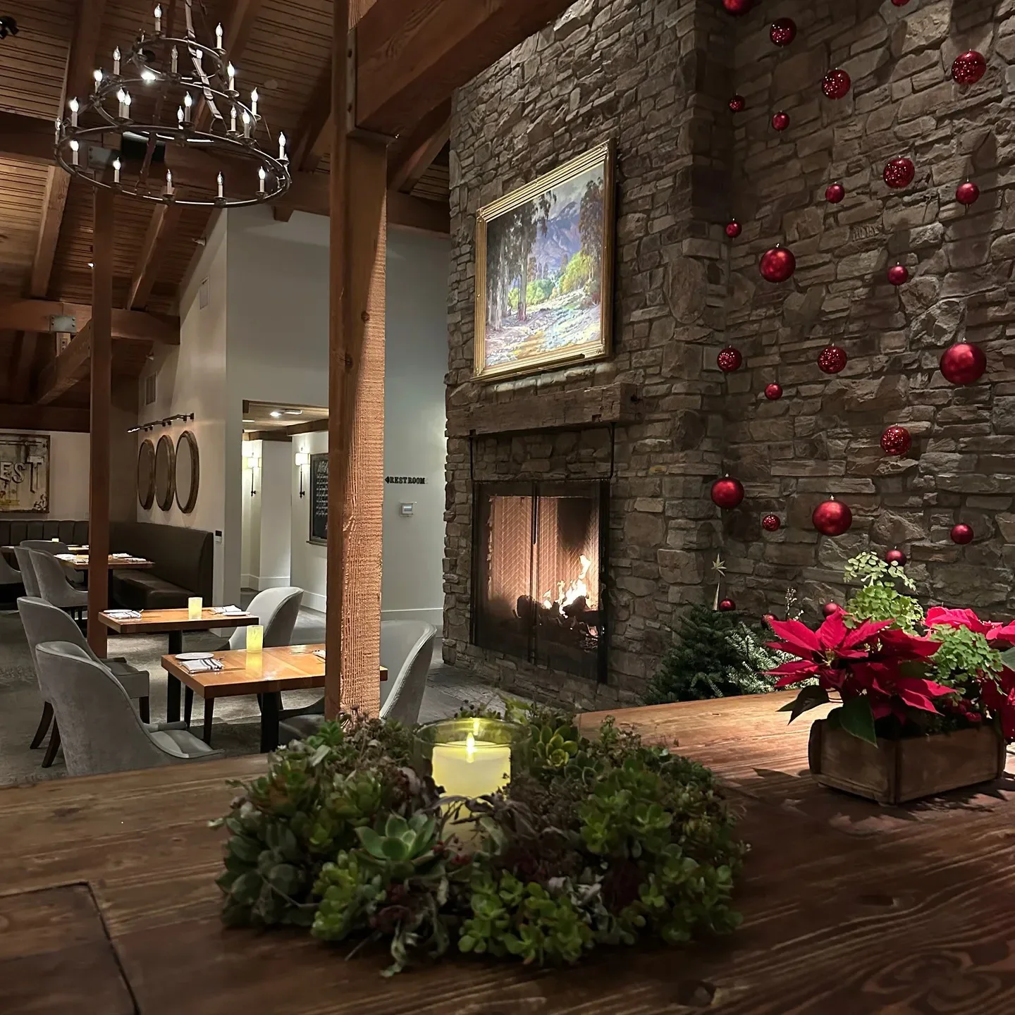 Cozy interior of Harvest Restaurant in Orange County with fireplace and festive decor.