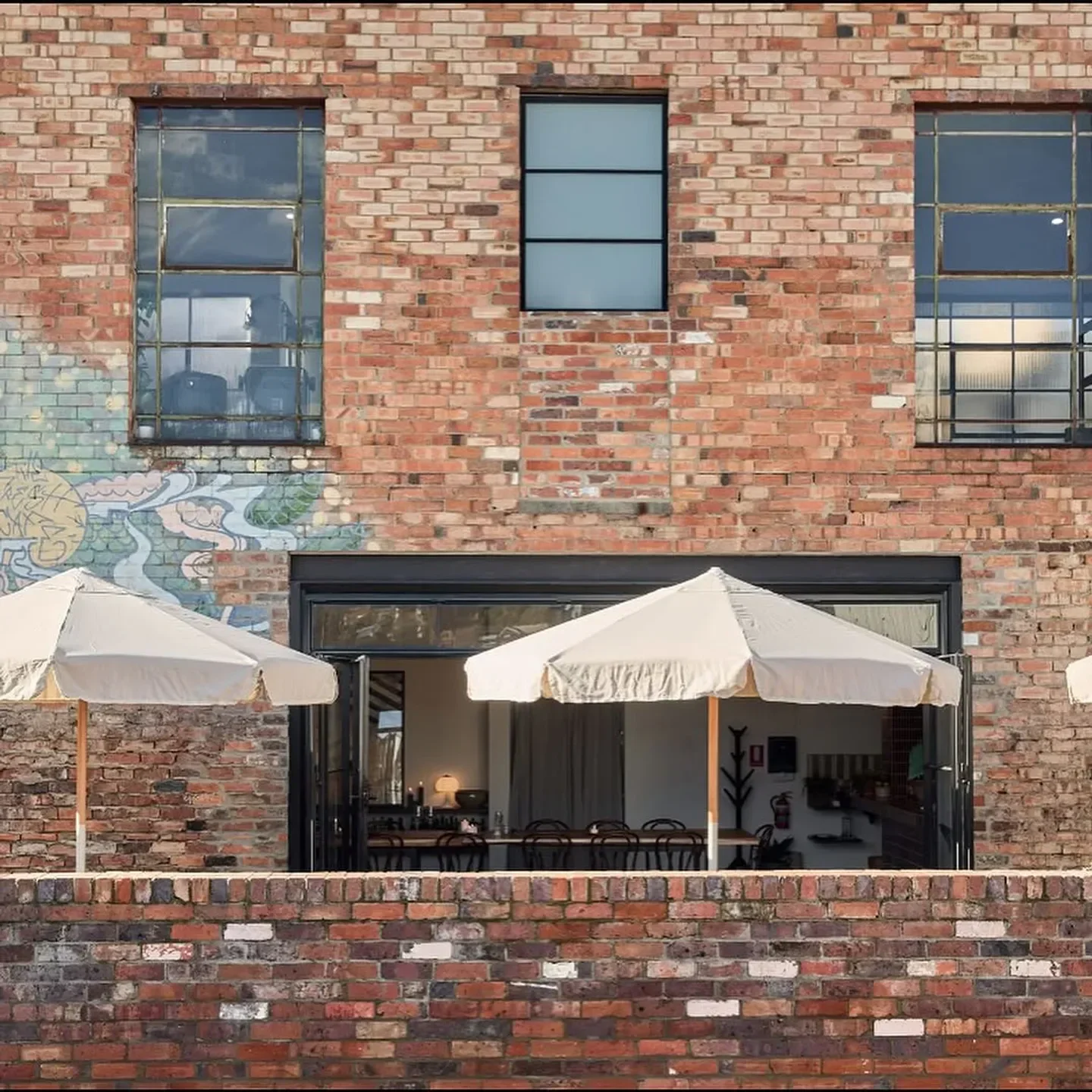 HAVILAH Restaurant in Launceston with outdoor umbrellas and exposed brick facade.