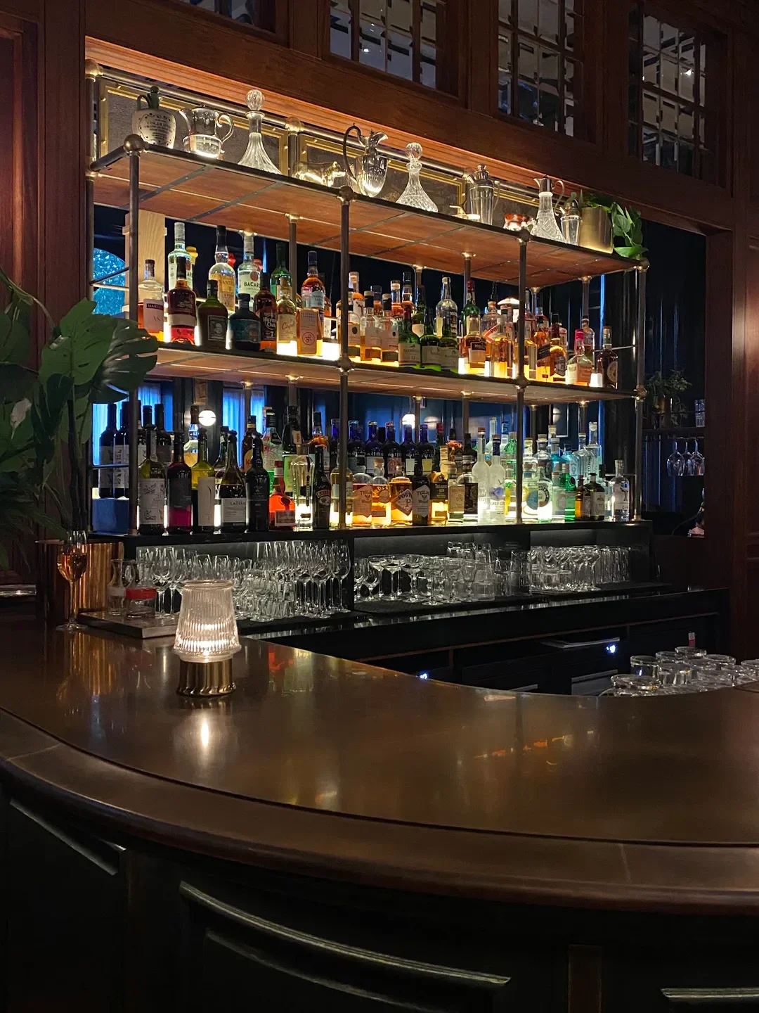 Well-stocked bar at Hawksmoor Dublin restaurant in Dublin, with stylish bottles and glasses.