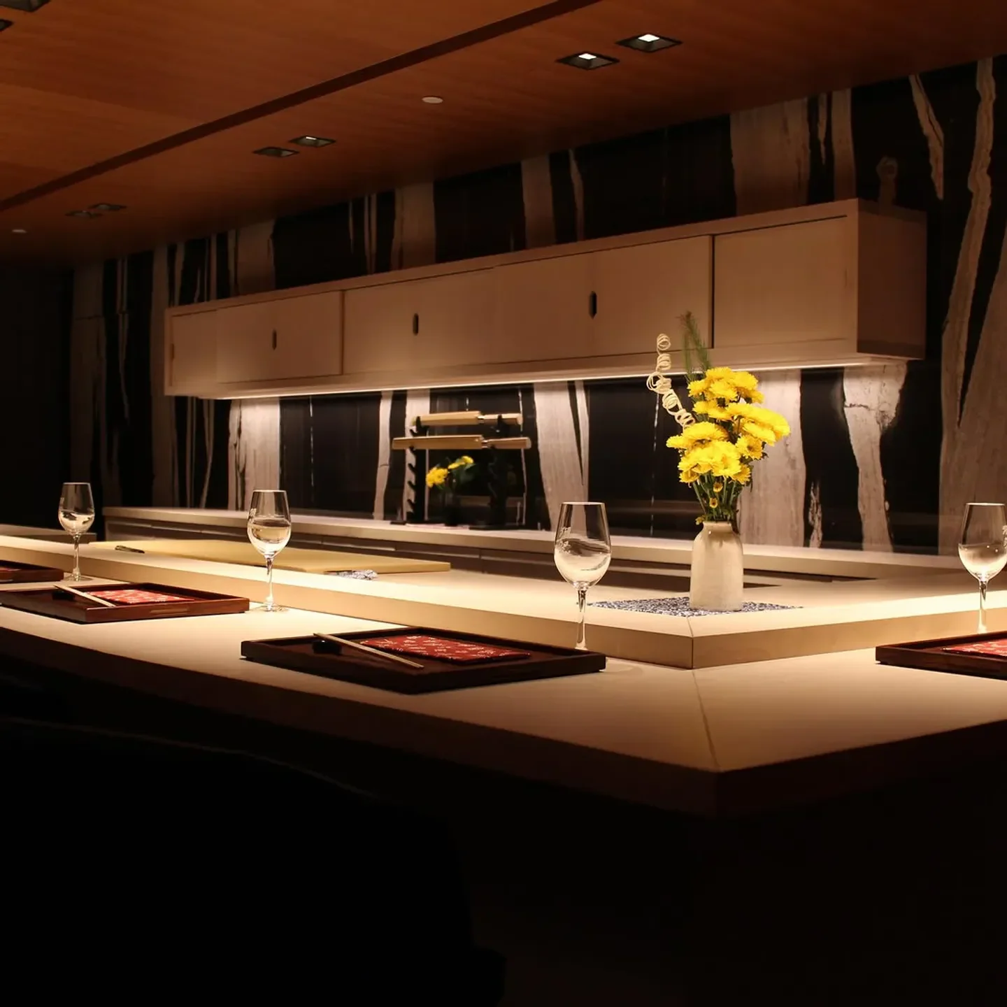 Elegant dining setting at Hayakawa, a stylish restaurant in Atlanta, featuring flower arrangement.