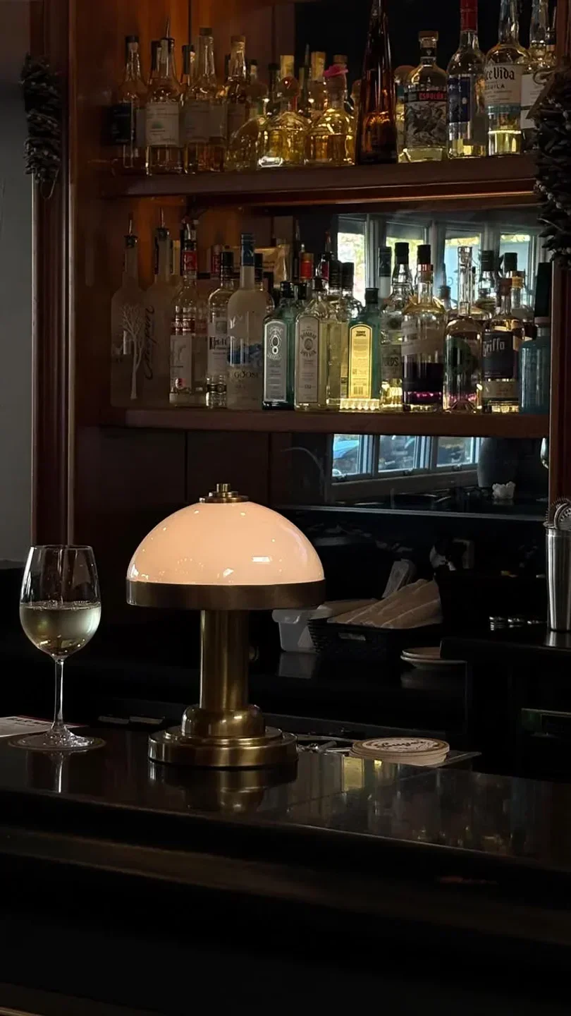 Cozy bar interior at Healdsburg Bar & Grill in Healdsburg, California, with wine and lamp.