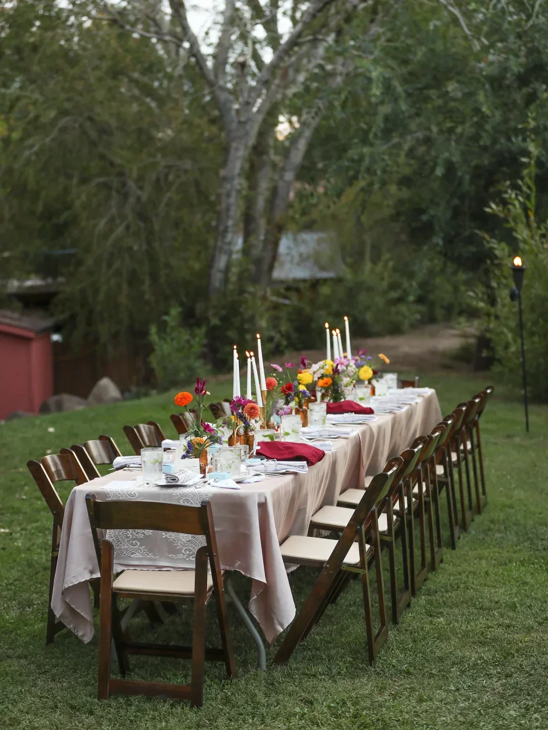 Outdoor dining at Hell's Backbone Grill & Farm in Boulder, long table with candles and flowers.