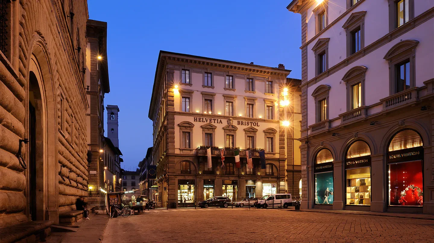 Street view of Helvetia & Bristol Firenze - Starhotels Collezione in Florence at dusk.