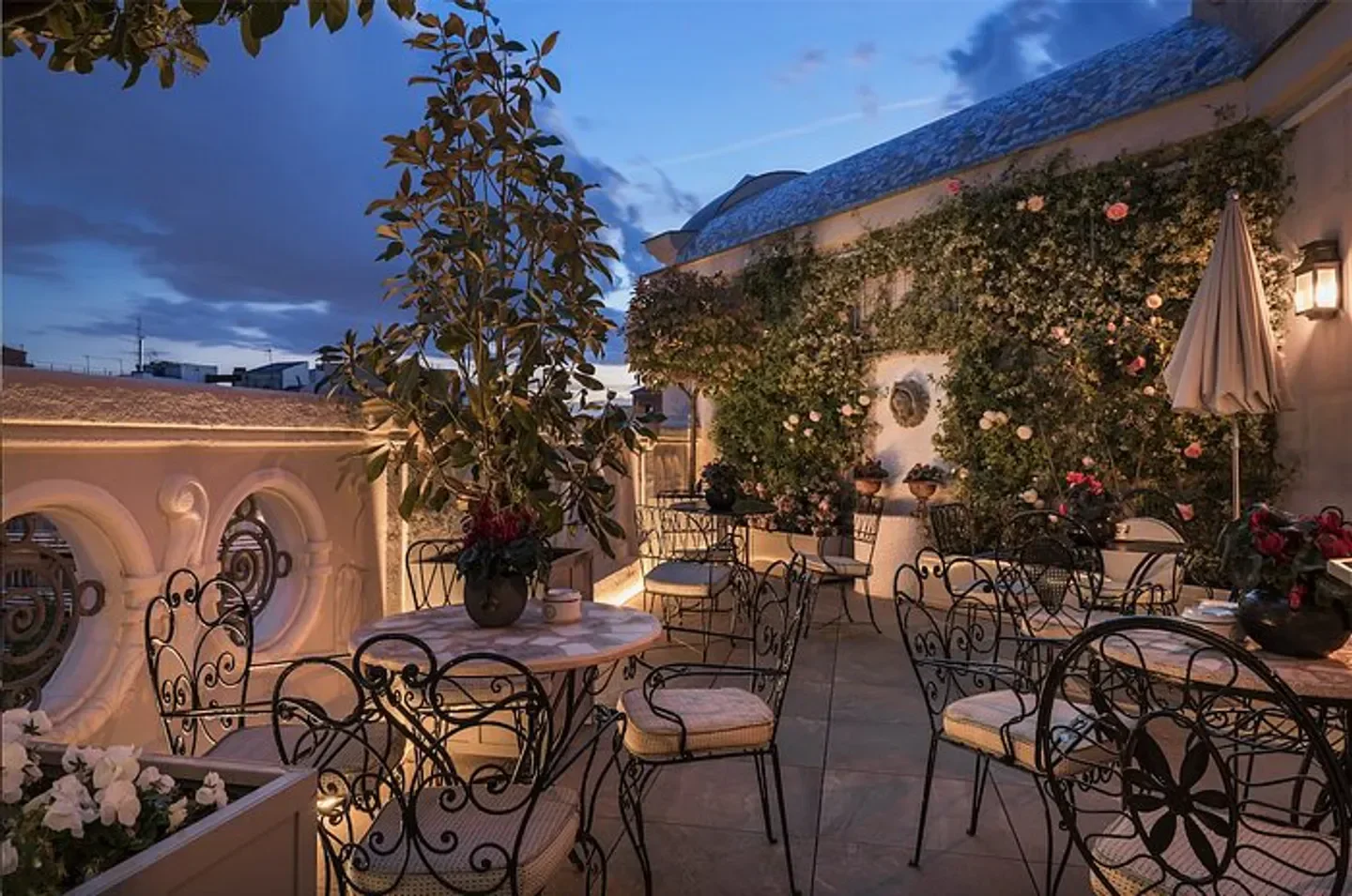 Rooftop terrace at Heritage Madrid restaurant in Madrid with elegant wrought-iron furniture.