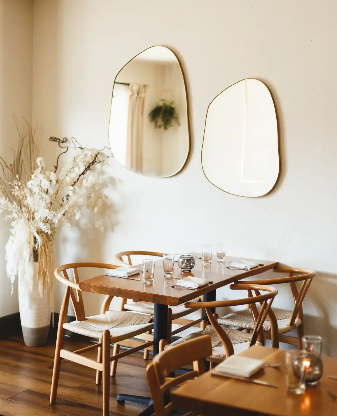 Dining space at Heritage restaurant in Orange County, featuring mirrors and wooden furniture.