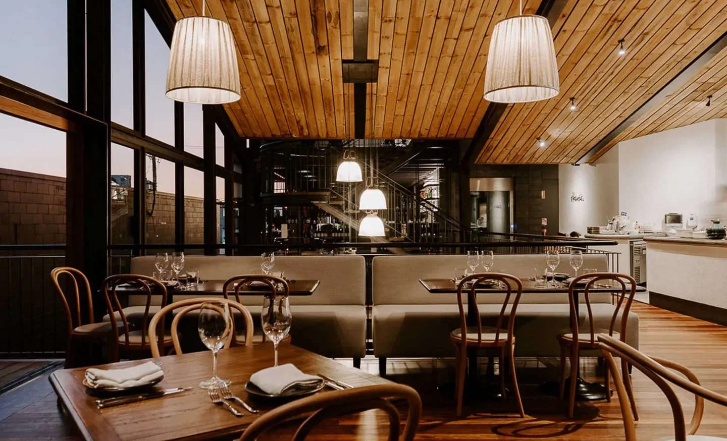 Interior dining space at Hervé’s Restaurant and Bar in Brisbane, with wooden ceiling and decor.