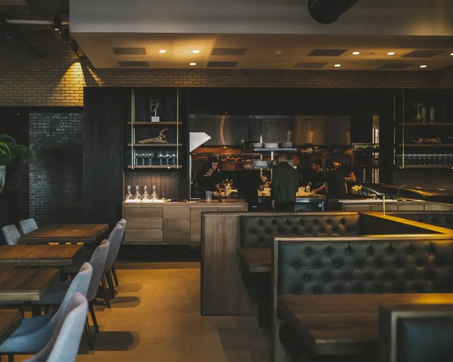 Hestia in Austin: Stylish restaurant interior with open kitchen and dining area.