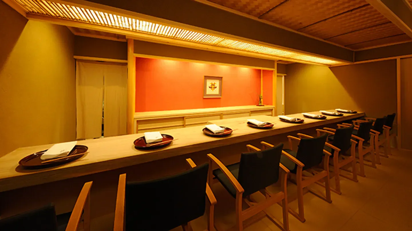 Interior dining space at Higashichaya Nakamura in Osaka, with table settings and chairs.