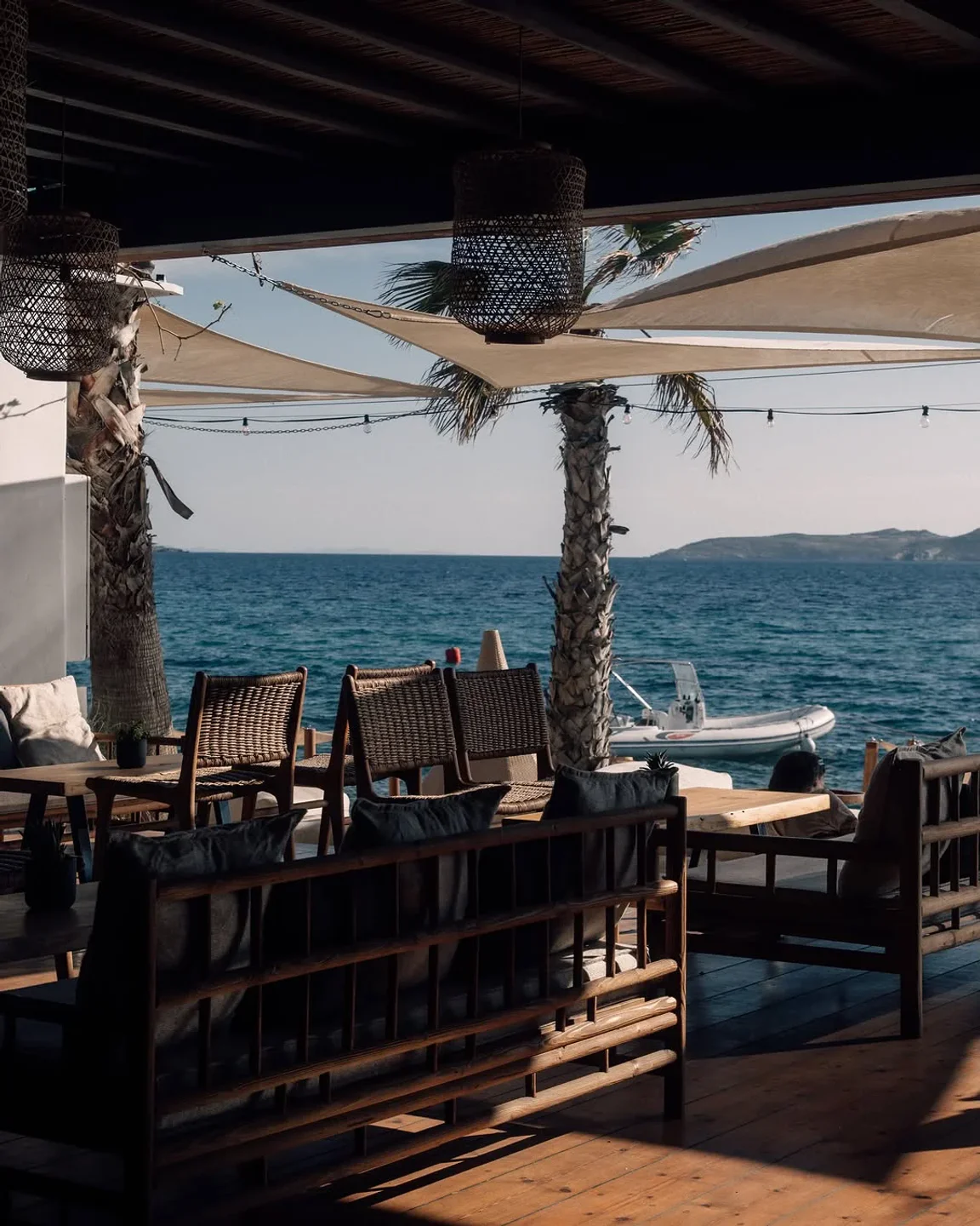 Hippie Fish beach club Mykonos with rustic seating and ocean views