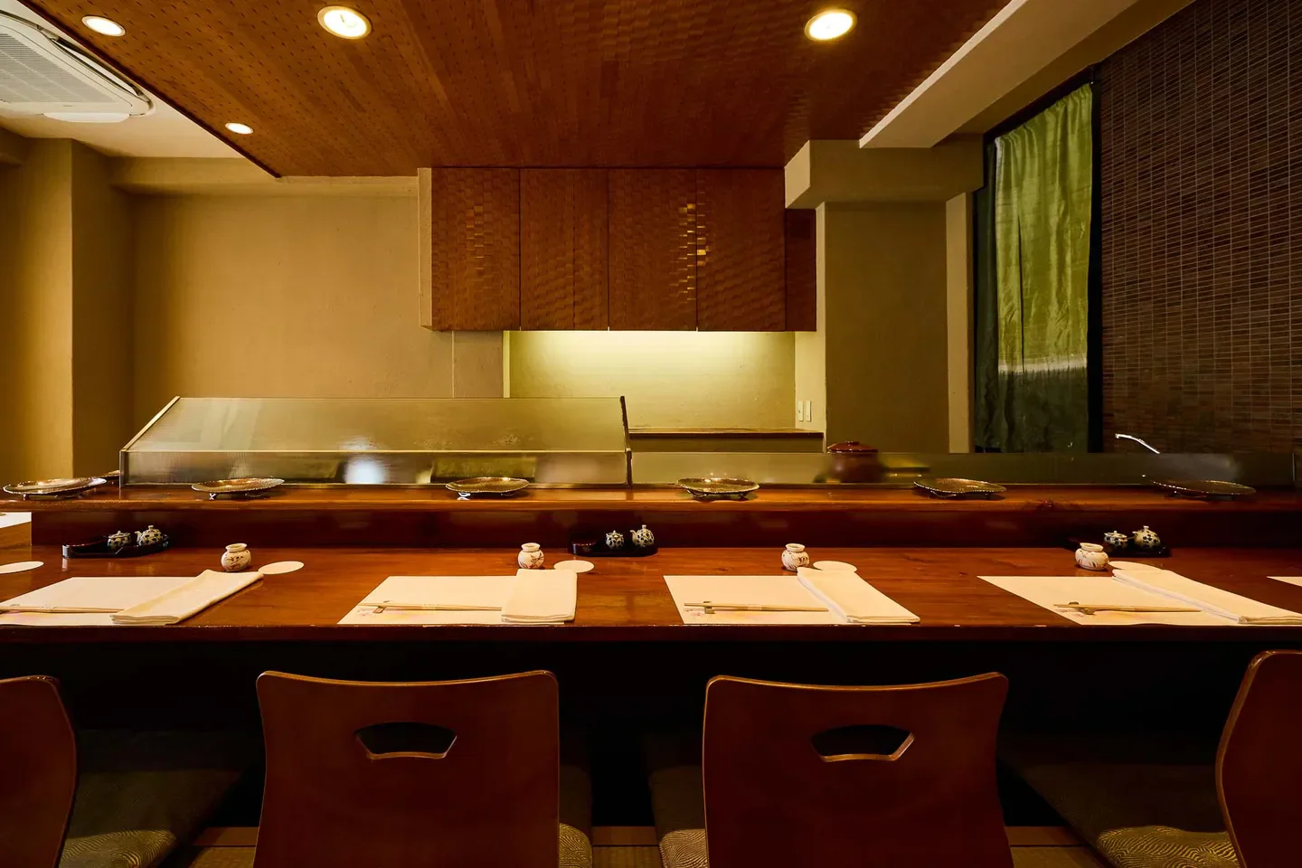 Interior of Hiraishi restaurant in Osaka, showing the sushi counter and seating.