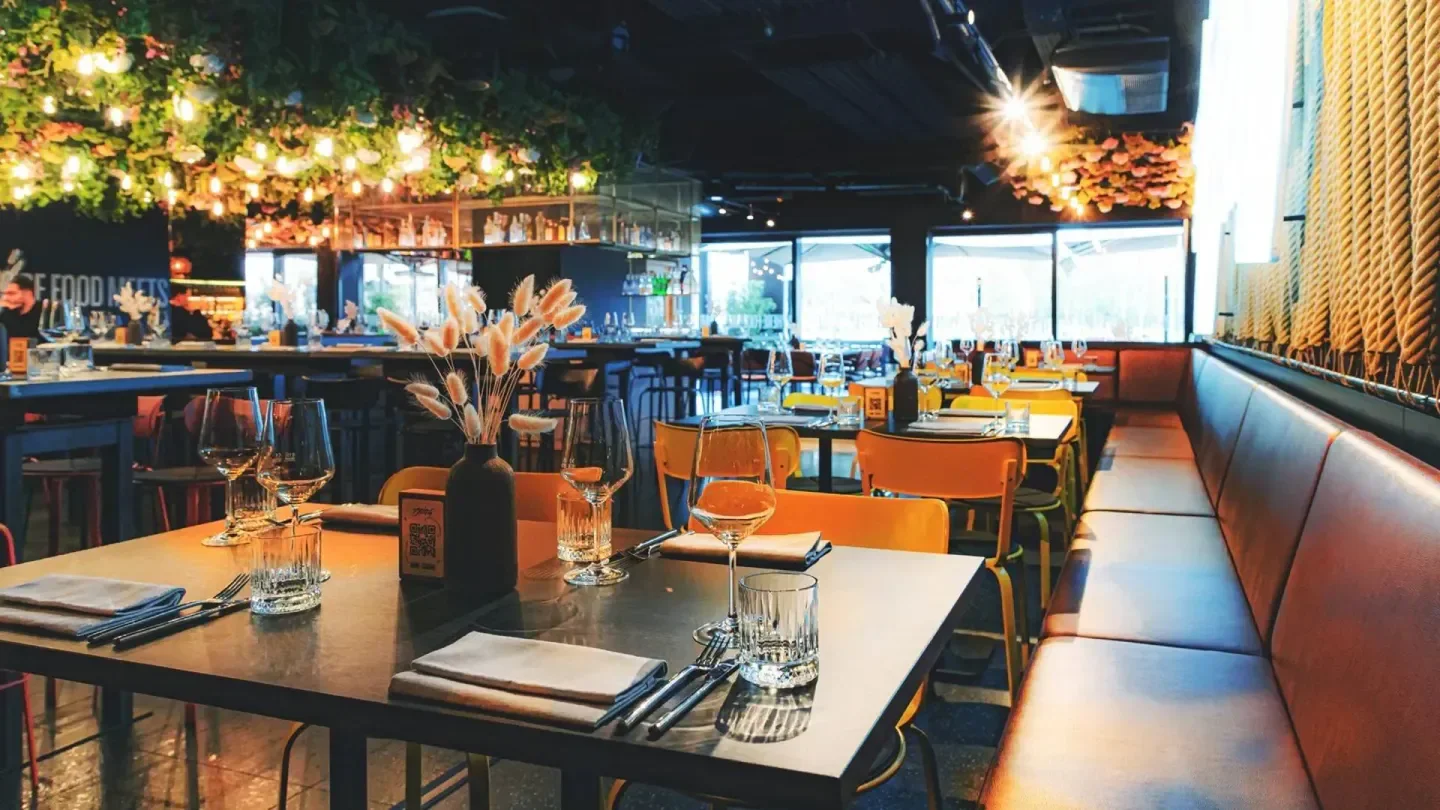 Interior dining at Hitch restaurant in Luxembourg, featuring stylish decor and floral accents.