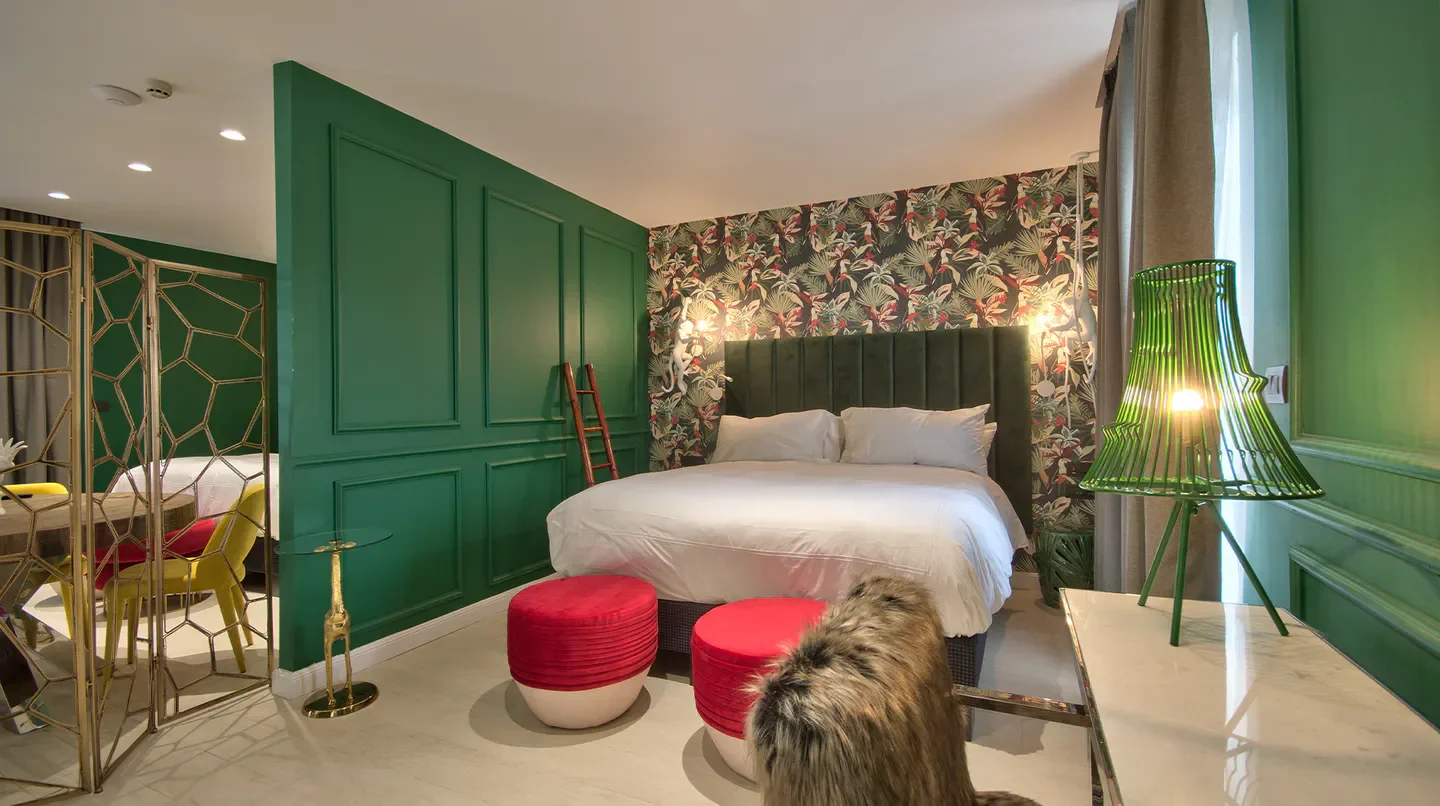 Stylish bedroom at HOLM Boutique & Spa in Malta with designer decor and vibrant colors.