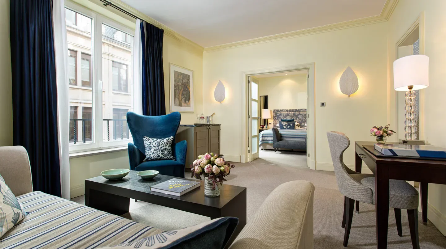 Elegant living area at Hotel Amigo, a Rocco Forte Hotel in Brussels, with city view.