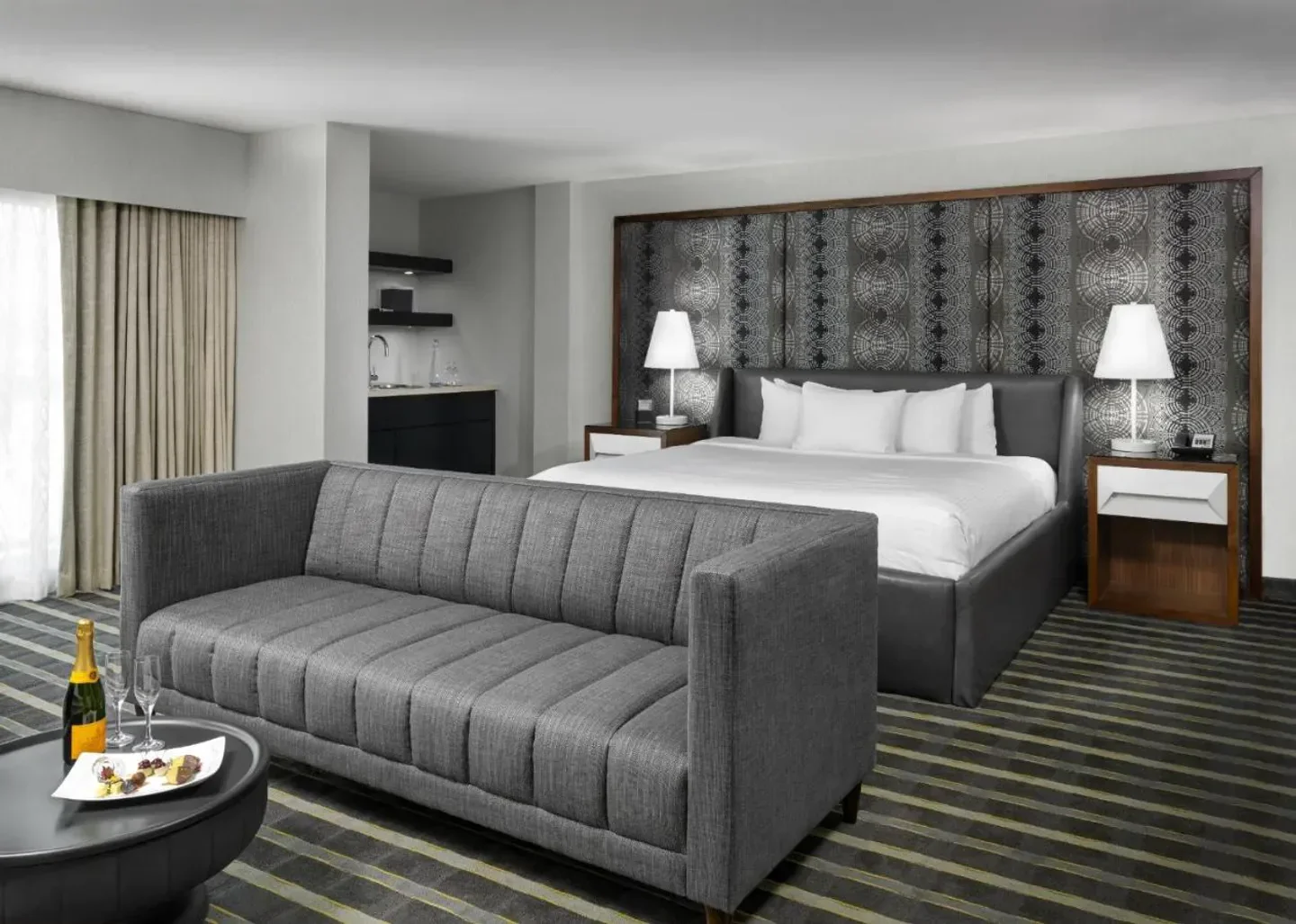 Stylish hotel room at Hotel Arts Barcelona, featuring a sofa and king-size bed in Barcelona.
