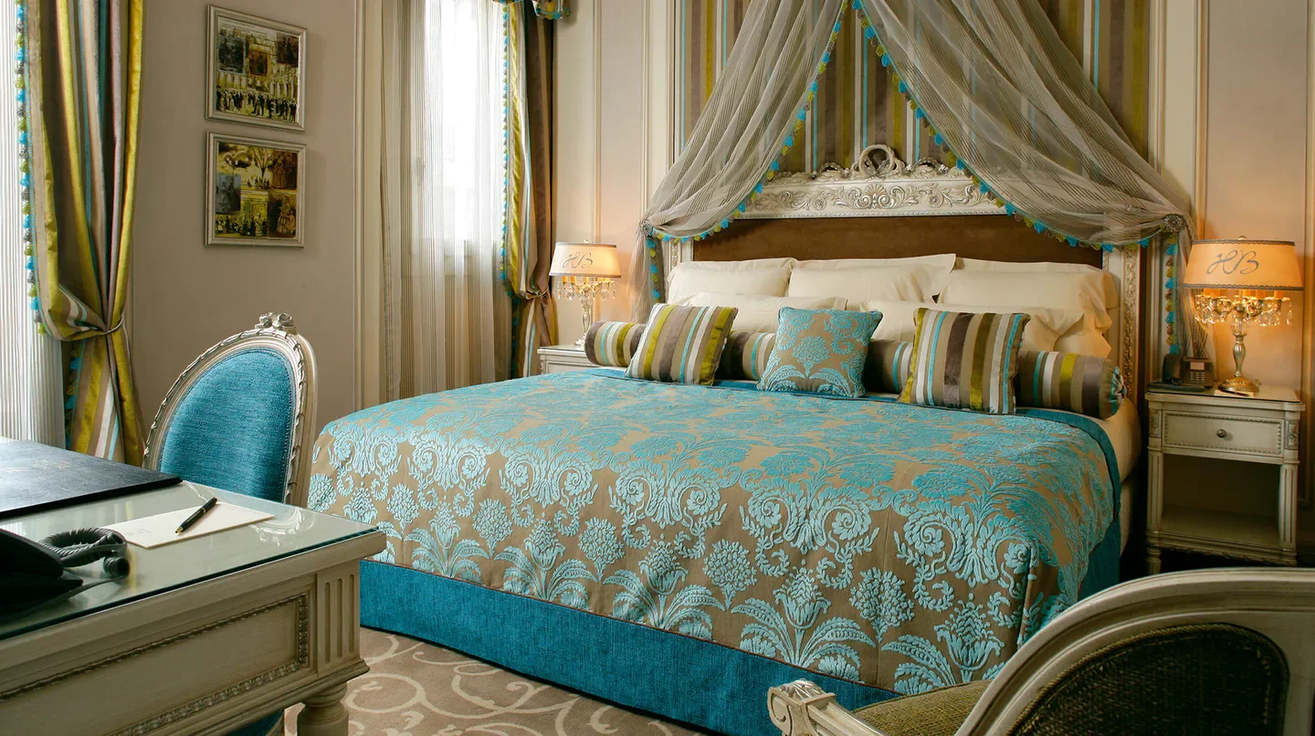 Elegant bedroom at Hotel Balzac in Paris, featuring a canopy bed and ornate decor.