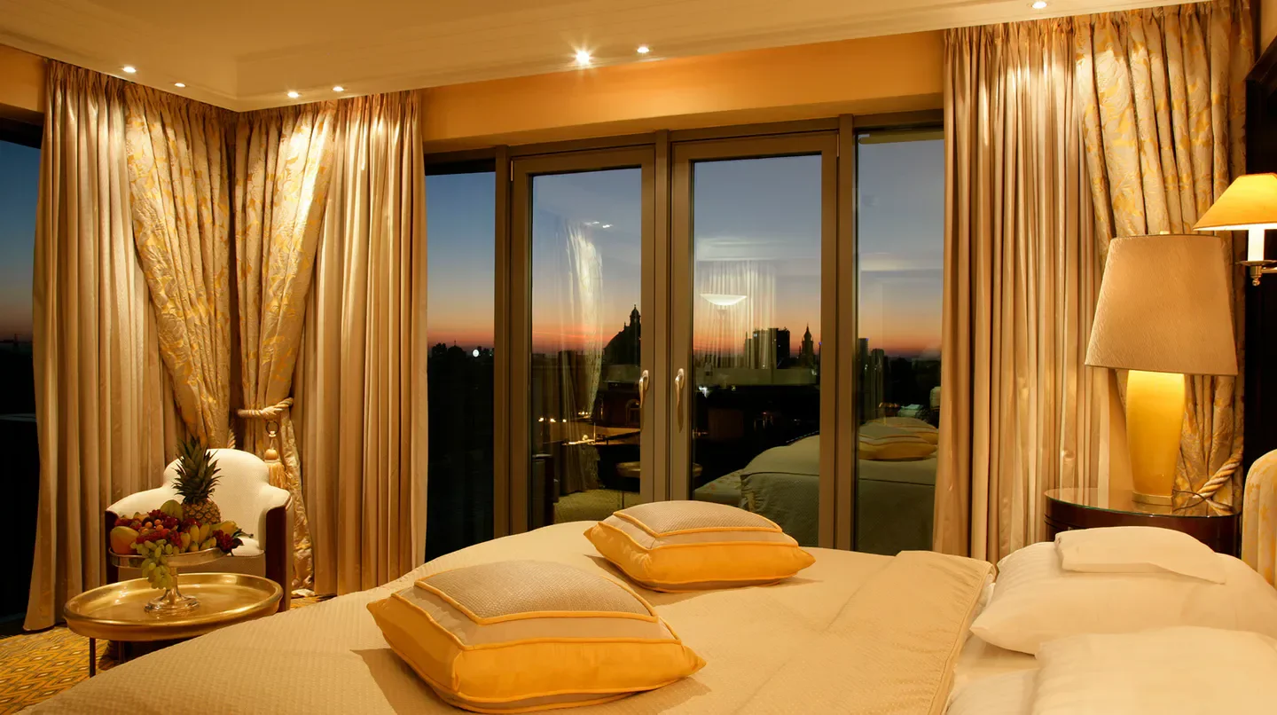 Hotel Bayerischer Hof bedroom in Munich with city view at sunset
