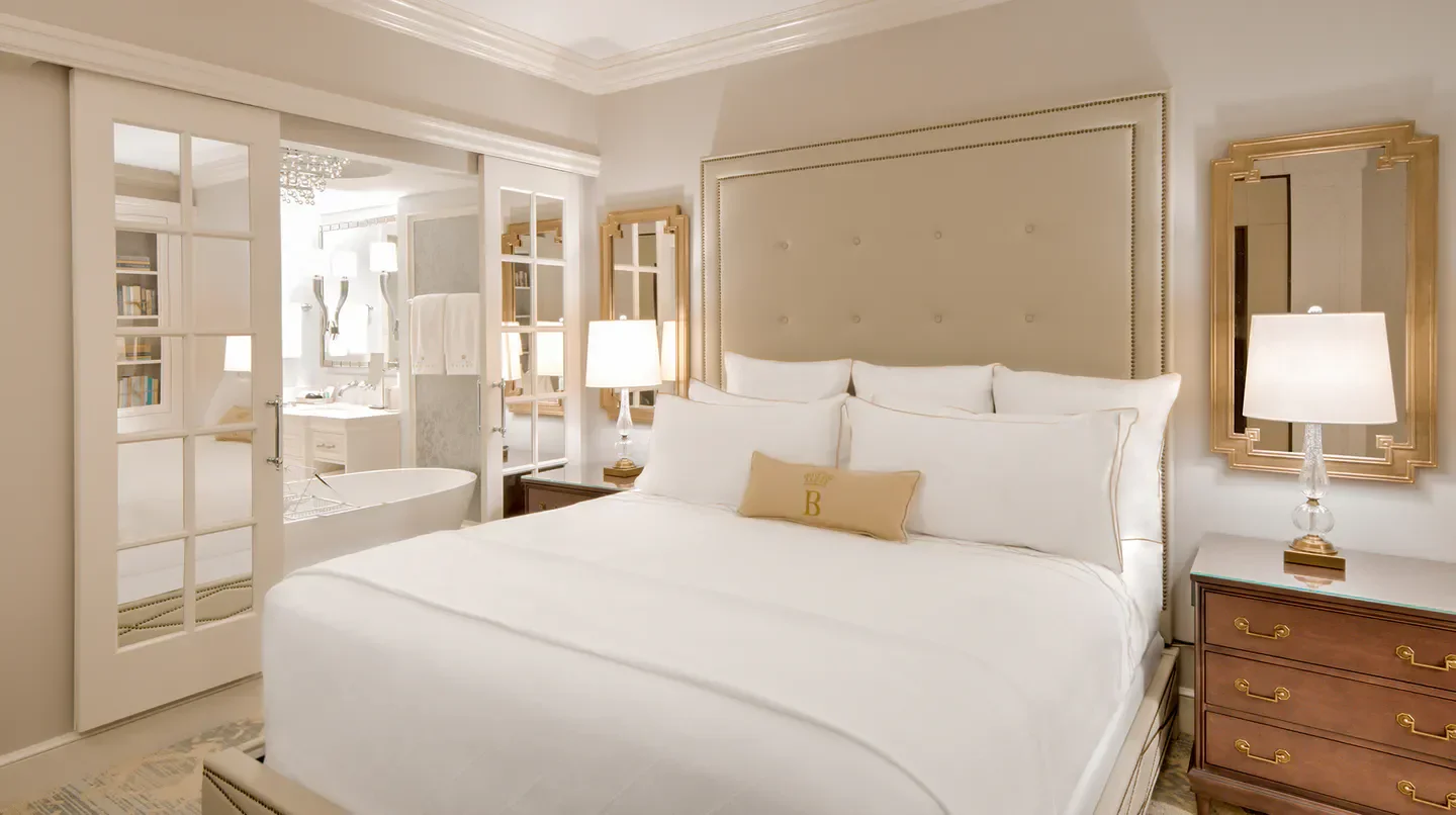 Elegant bedroom at Hotel Bennett in Charleston, featuring luxurious linens and decor.