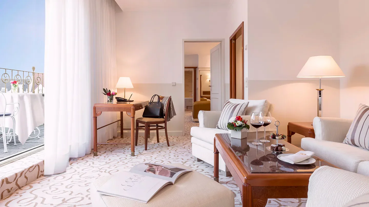 Elegant suite at Hotel Bristol Berlin, Berlin. Features a balcony and luxurious interior design.