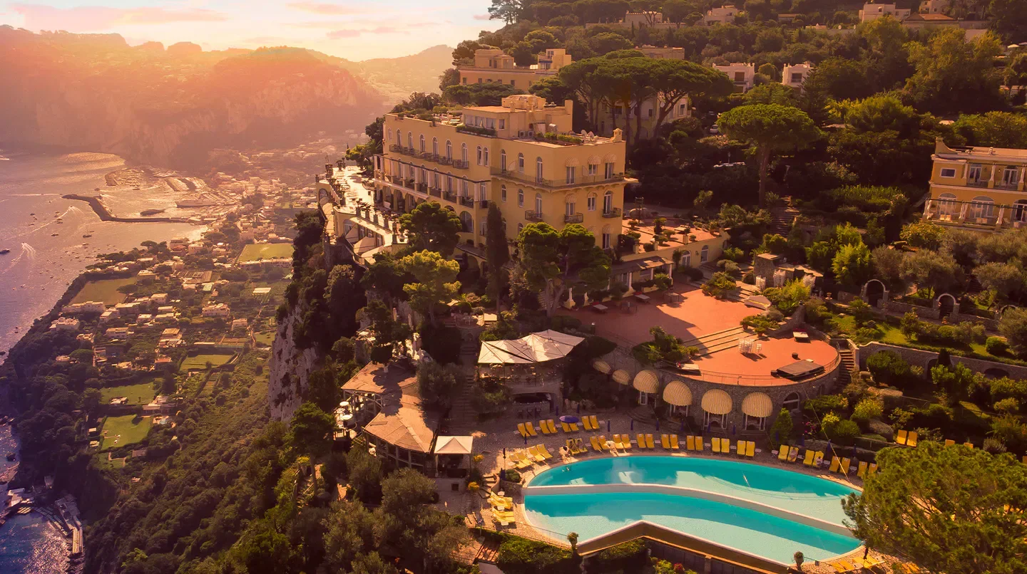 Aerial view of Hotel Caesar Augustus in Anacapri, Italy, overlooking the stunning coastline.
