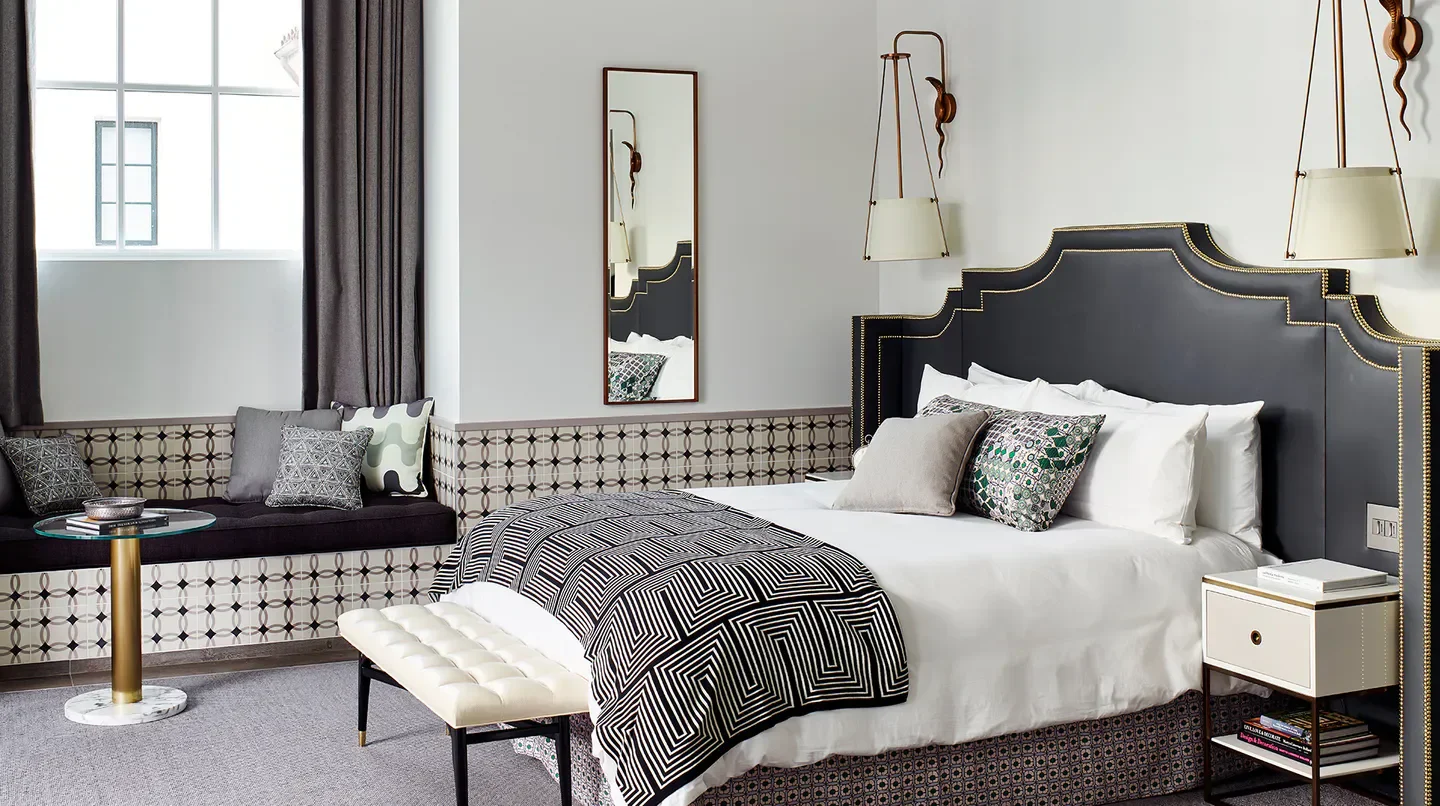 Stylish bedroom interior at Hotel Californian in Santa Barbara, featuring luxury bedding and design.