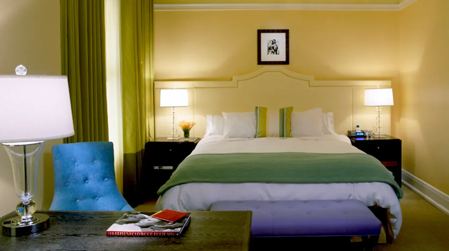 Cozy bedroom at Hotel deLuxe in Portland, featuring stylish decor and comfortable bed